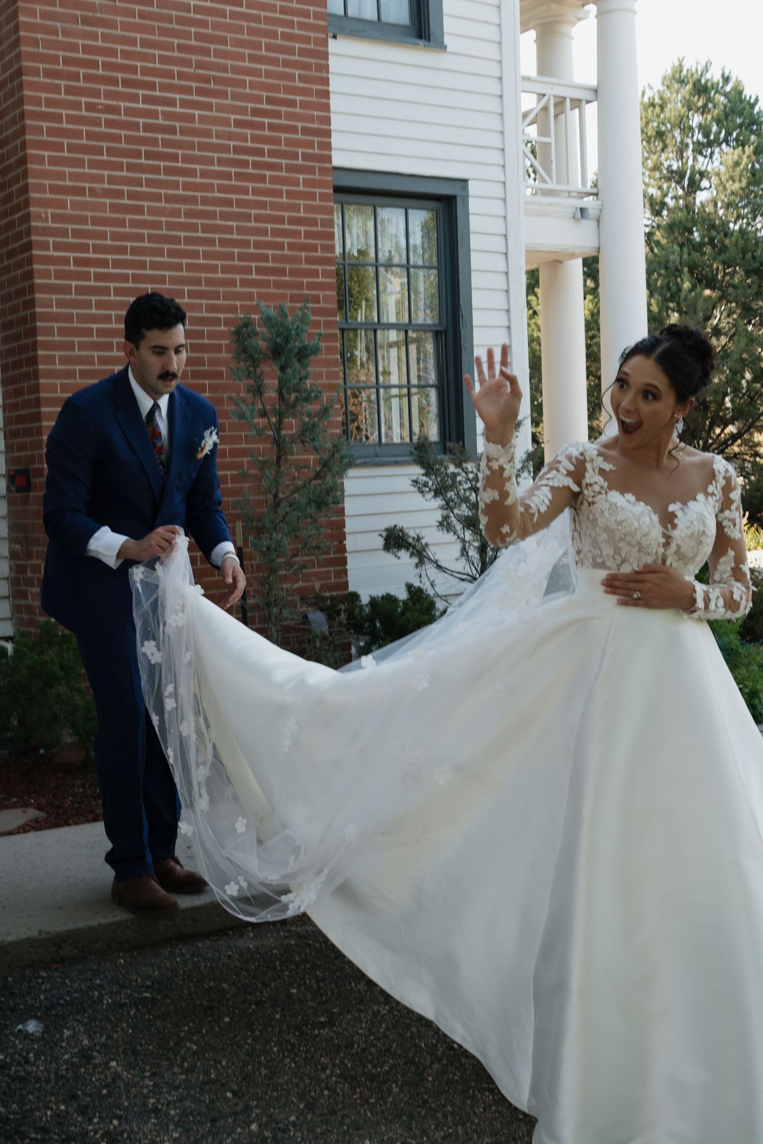A series of wedding photos showing a bride in a white gown with lace details outside a brick building.