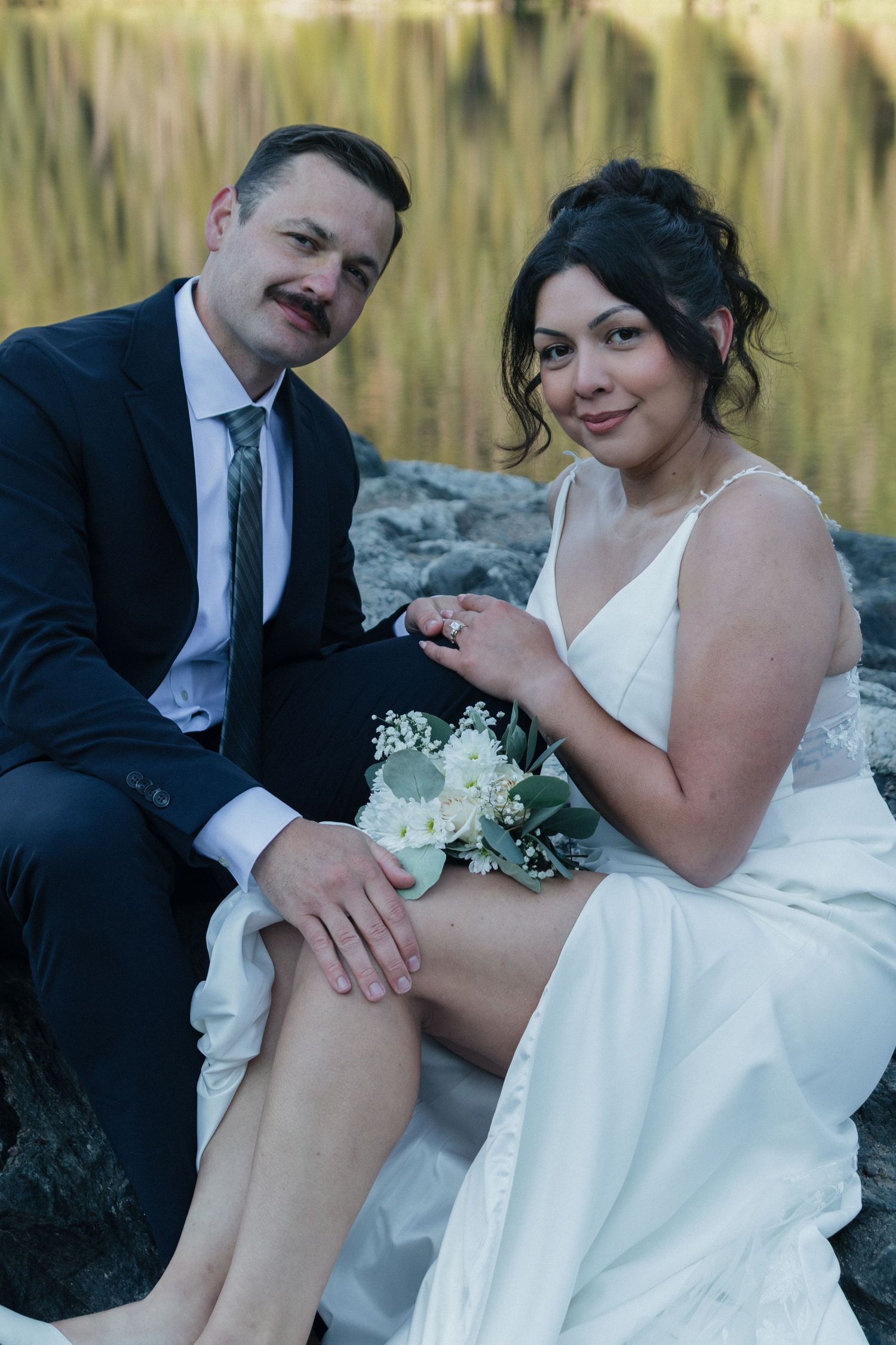 An intimate wedding couple takes romantic portraits in a golden wheat field.