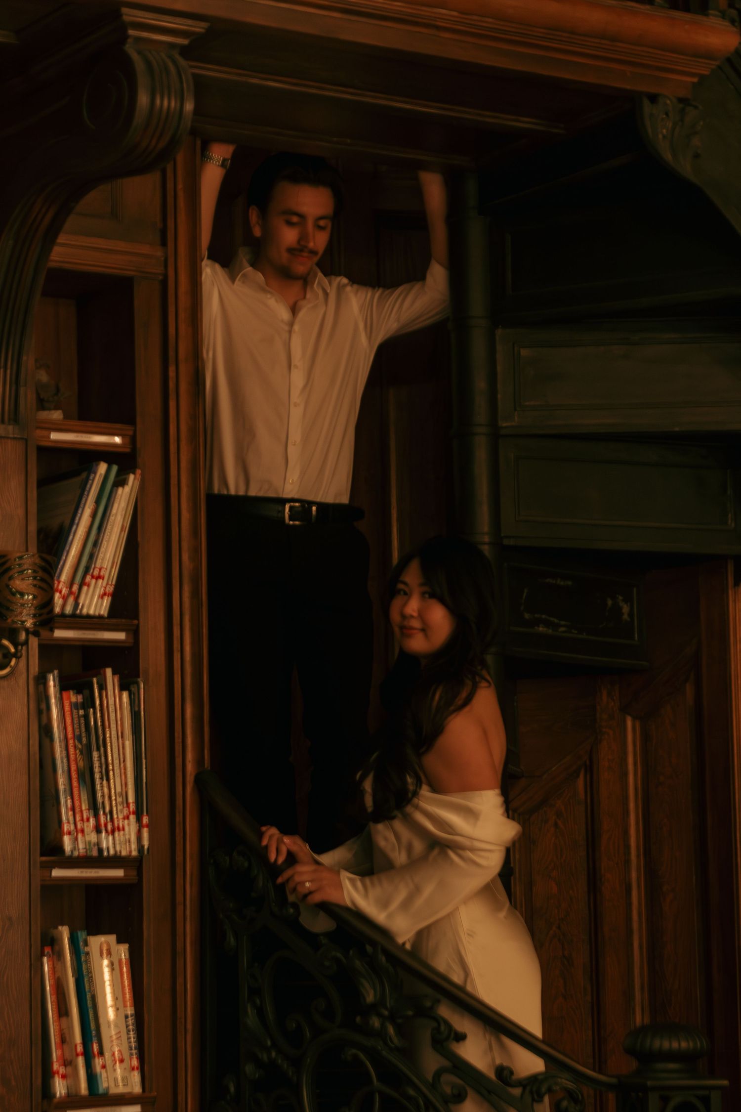 Series of photos showing someone organizing books on wooden library shelves.
