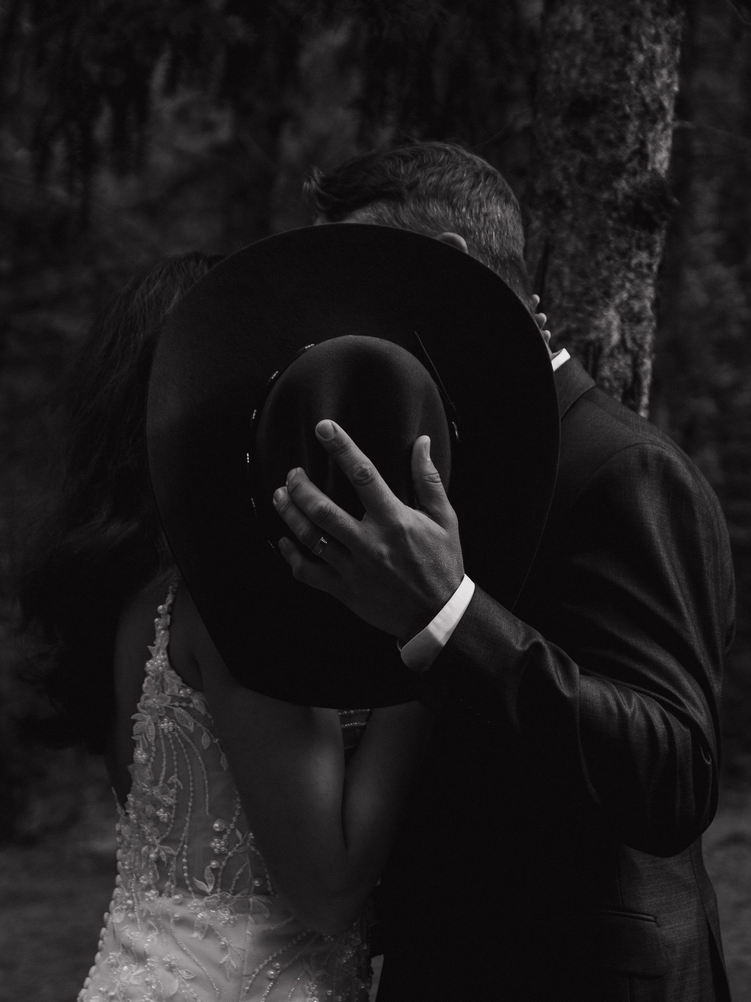 Artistic black and white wedding photography sequence showing an intimate moment between newlyweds.