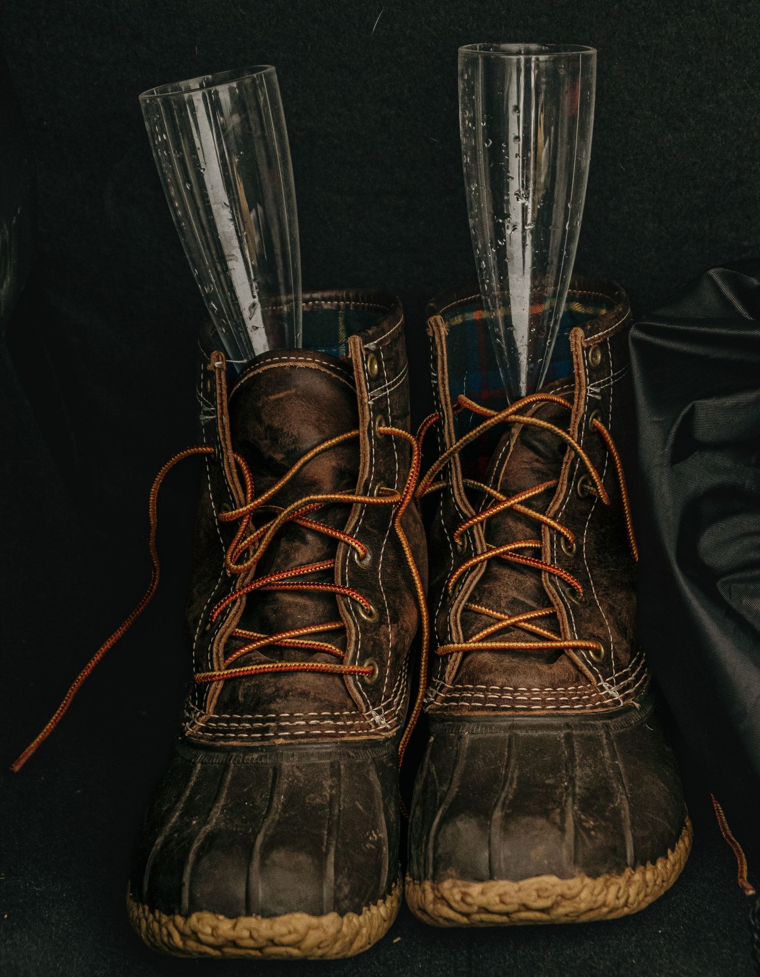 Vintage leather duck boots photographed against a dark background.