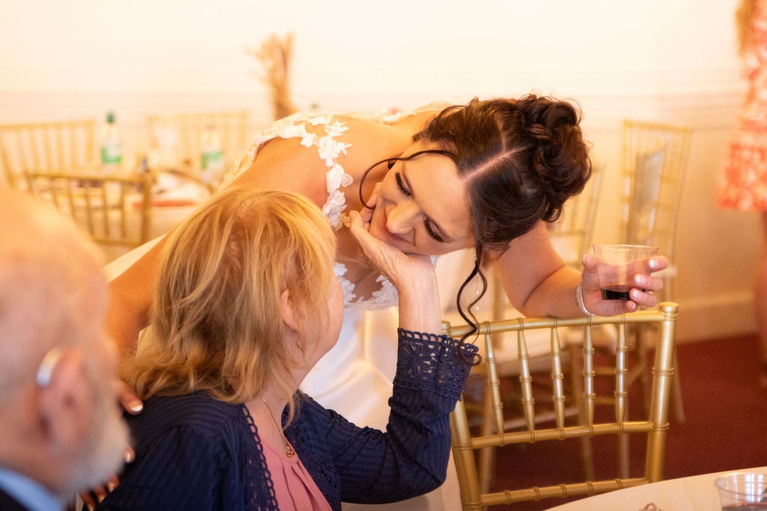 Wedding reception candid moments captured in warm lighting.