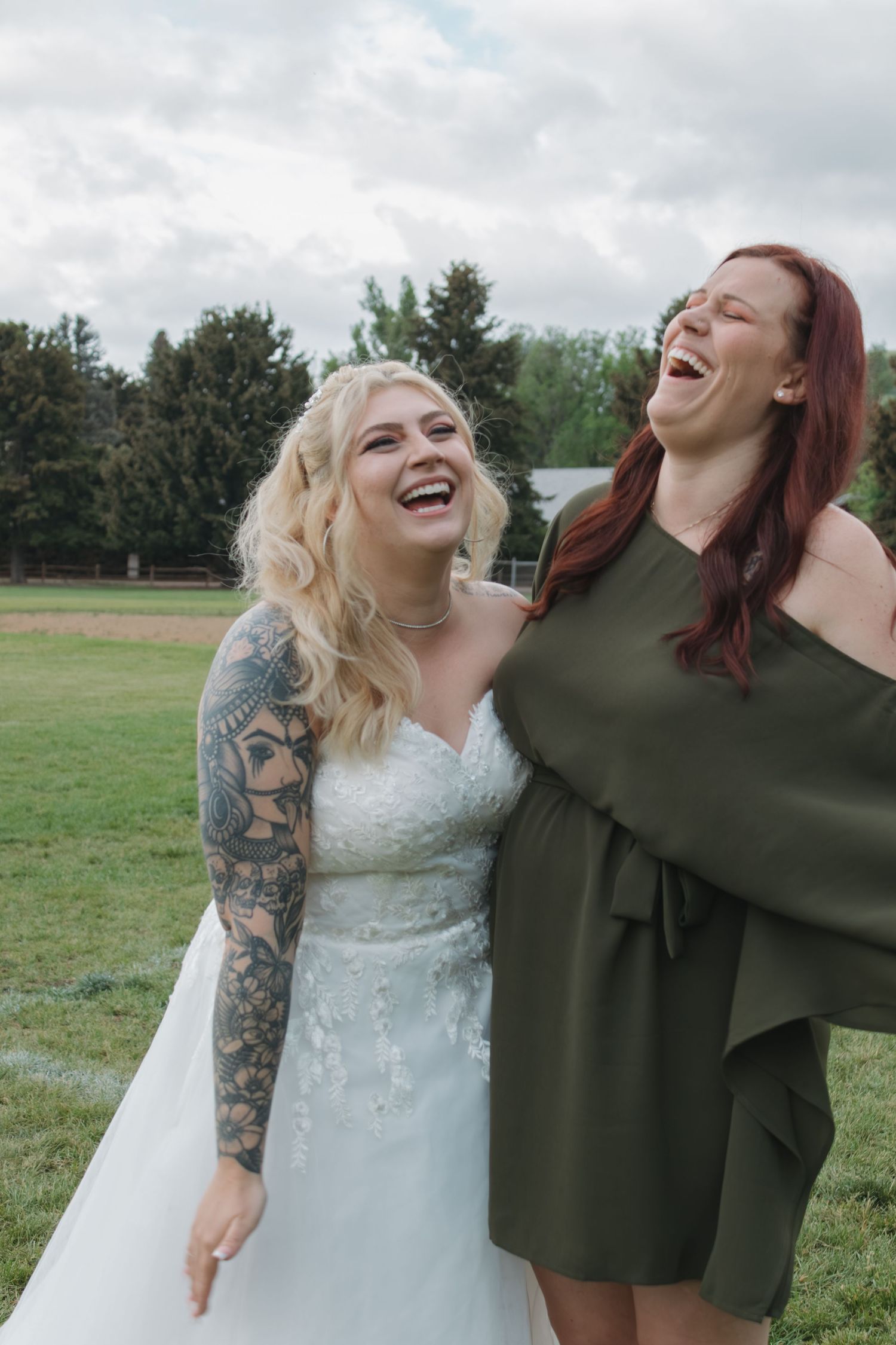 Genuine laughter shared between two people during an outdoor photoshoot.