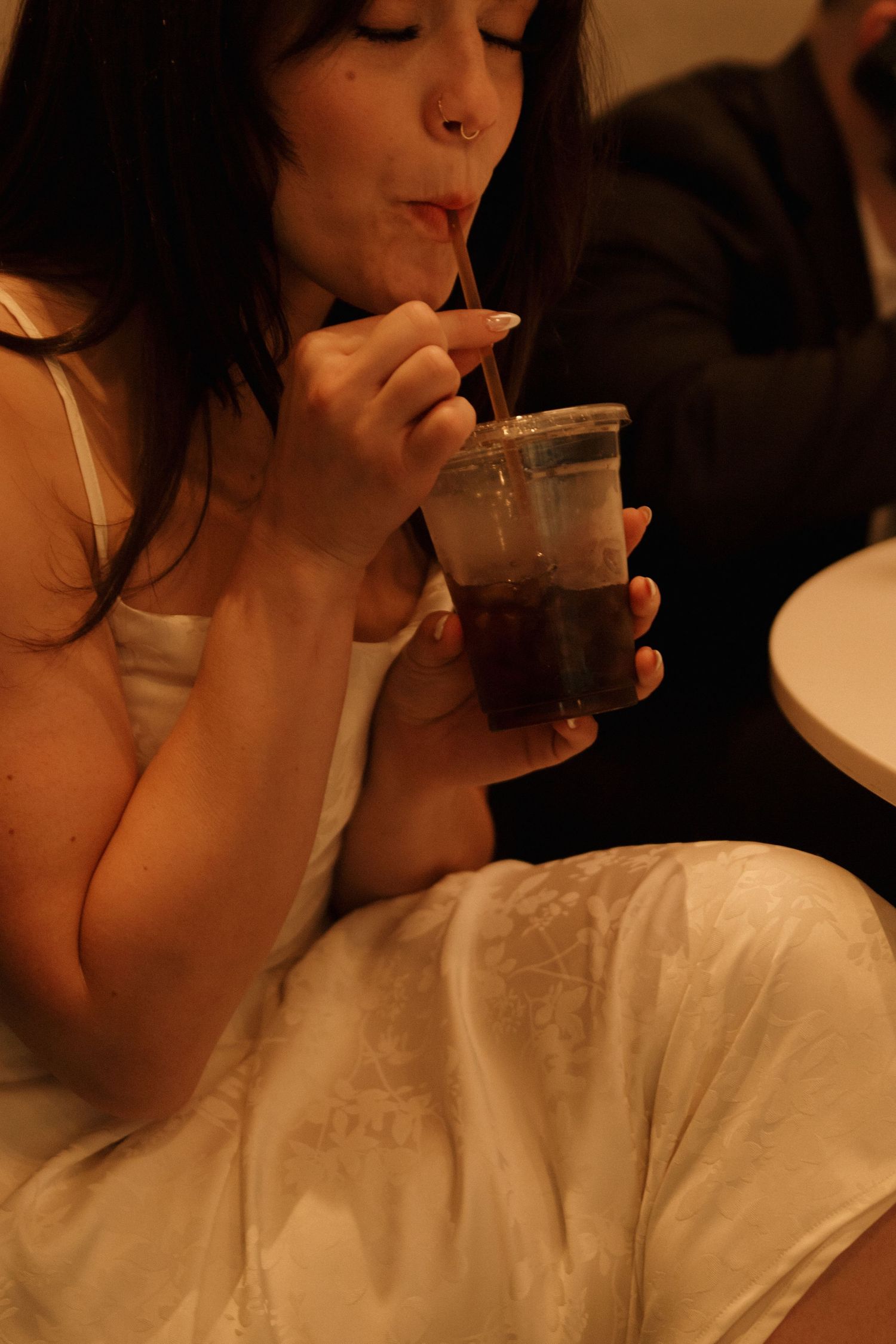 Series of sequential shots showing someone sipping from a glass in warm lighting.