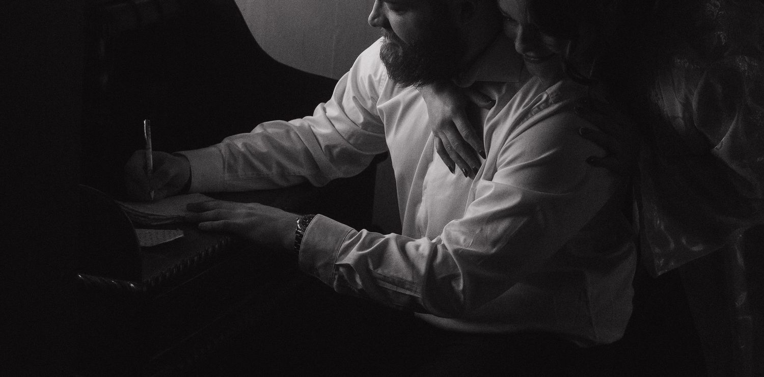 Dramatic black and white getting ready sequence with moody lighting.