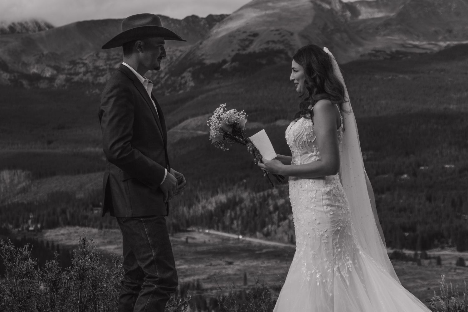 Wedding couple shares romantic moments against a backdrop of majestic mountain landscapes.