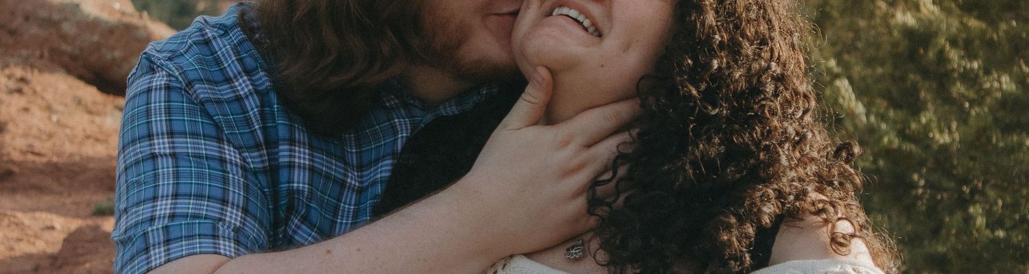 A joyful candid moment captured between two people outdoors.