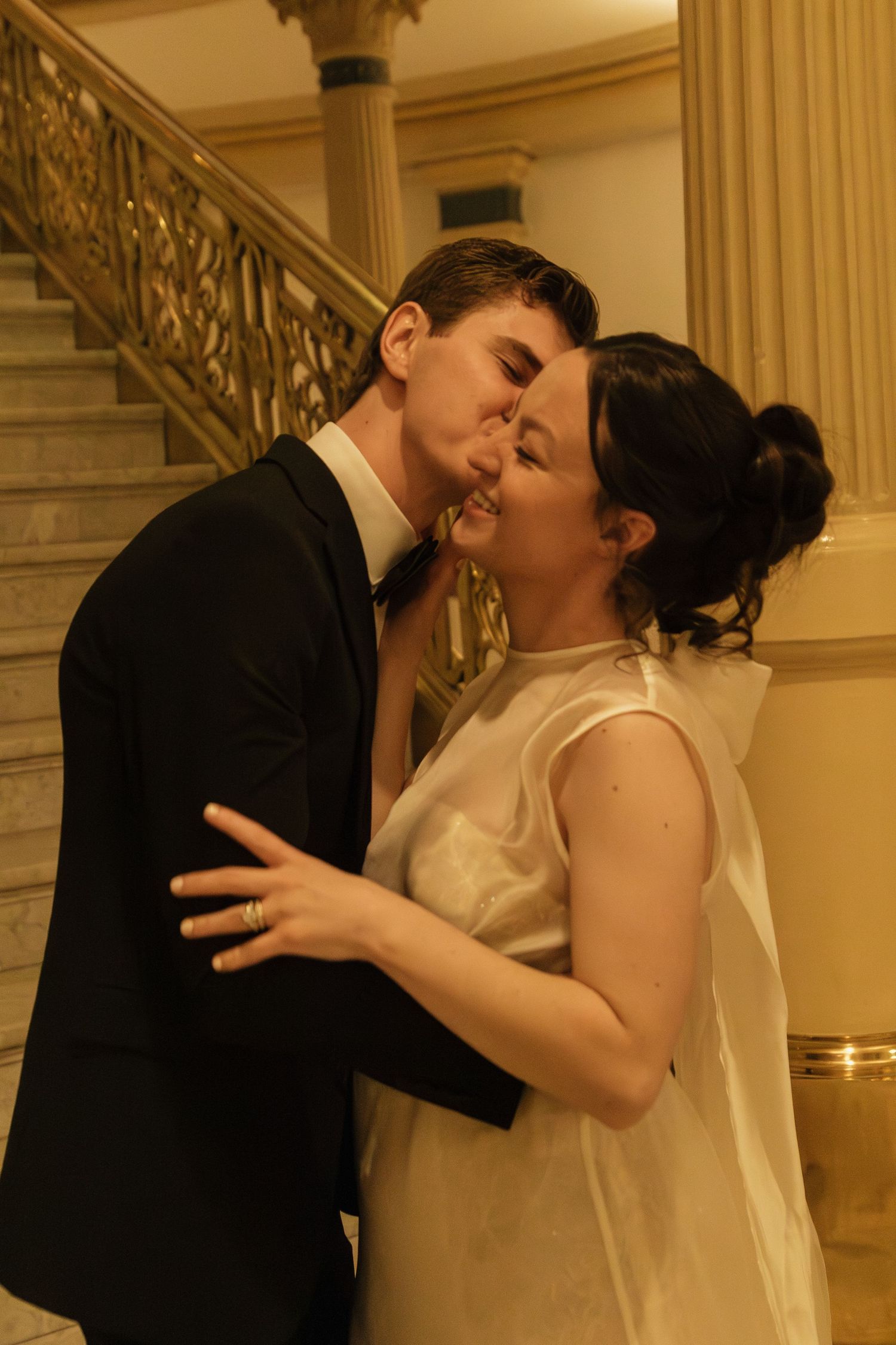 A romantic sequence of a couple sharing a kiss in formal wedding attire.