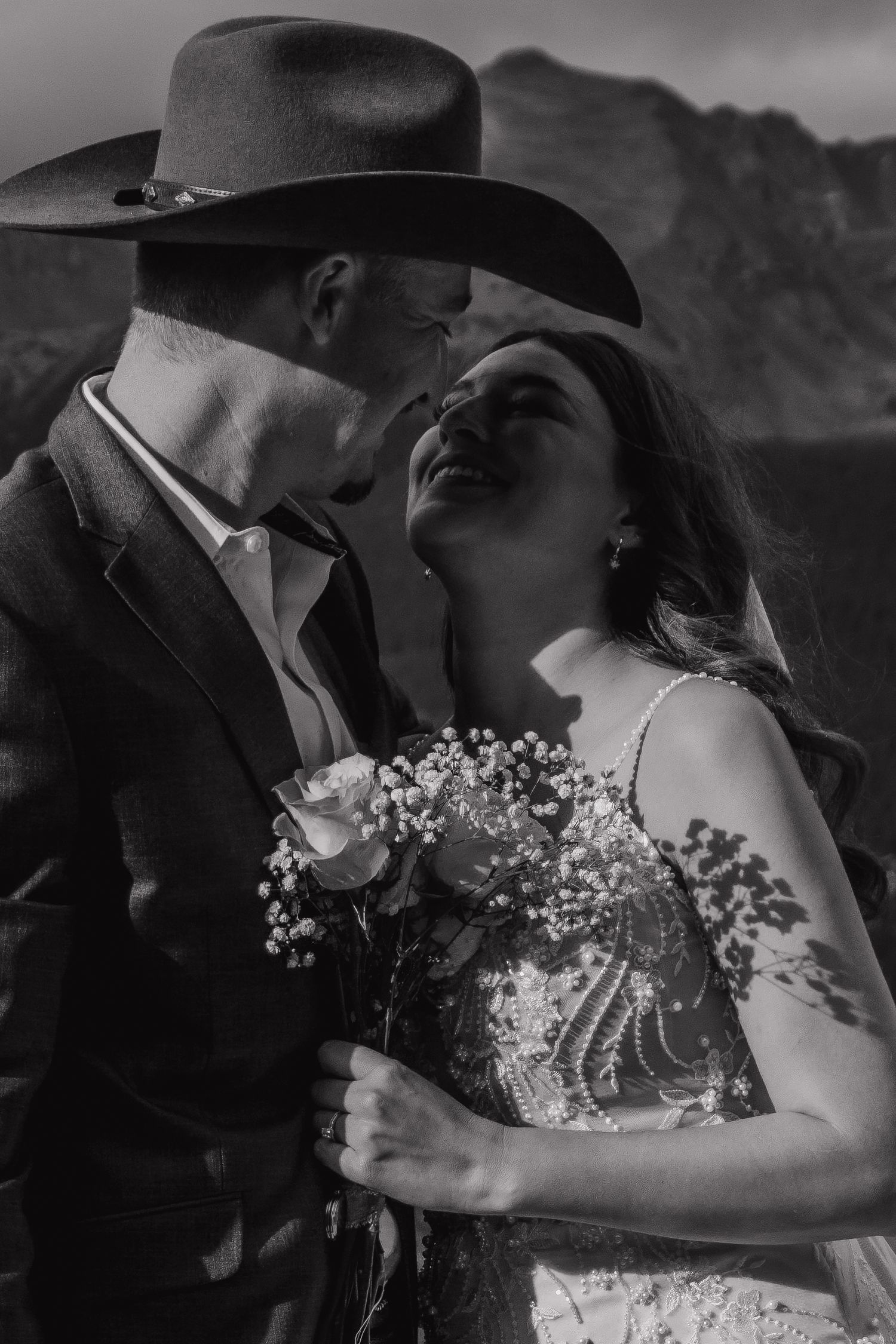 A romantic black and white wedding photo sequence showing a couple sharing intimate moments with baby's breath flowers.