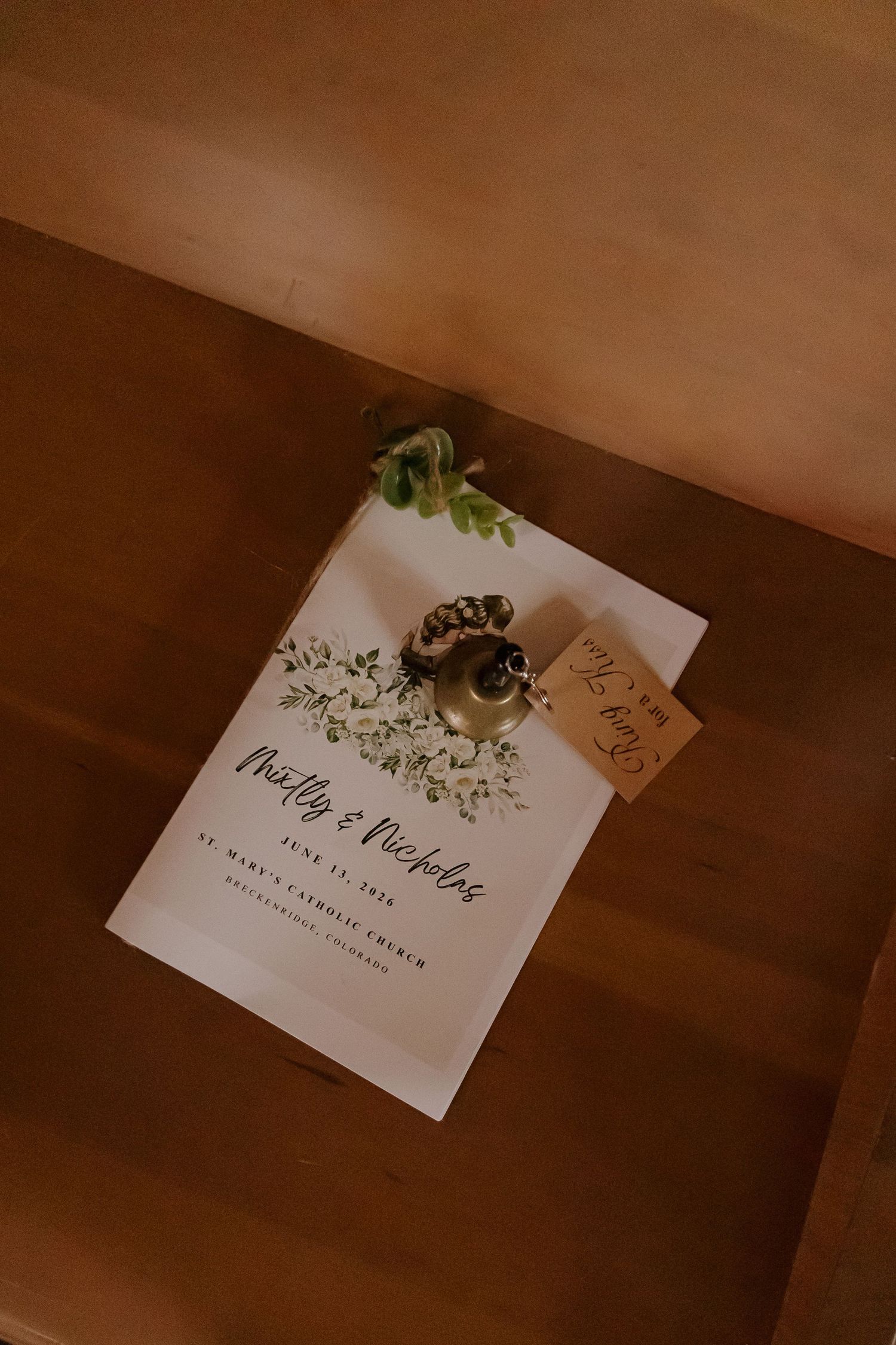 Elegant wedding program for Noelly and Nicholas on June 13, 2024, at St. Mary's Catholic Church with floral accents.