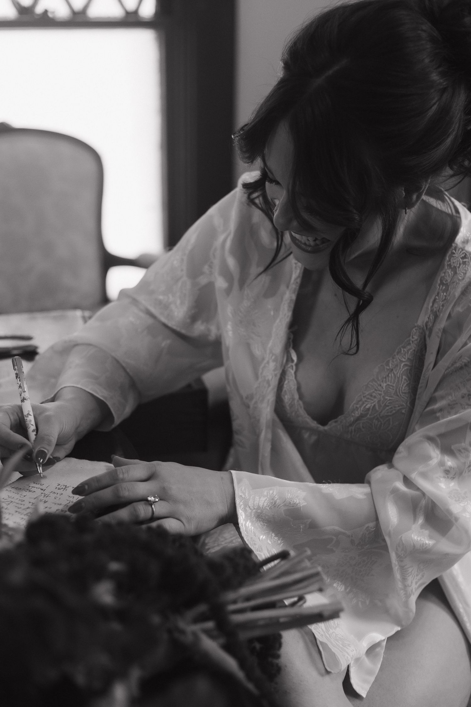 A close-up shot shows someone writing in black and white.