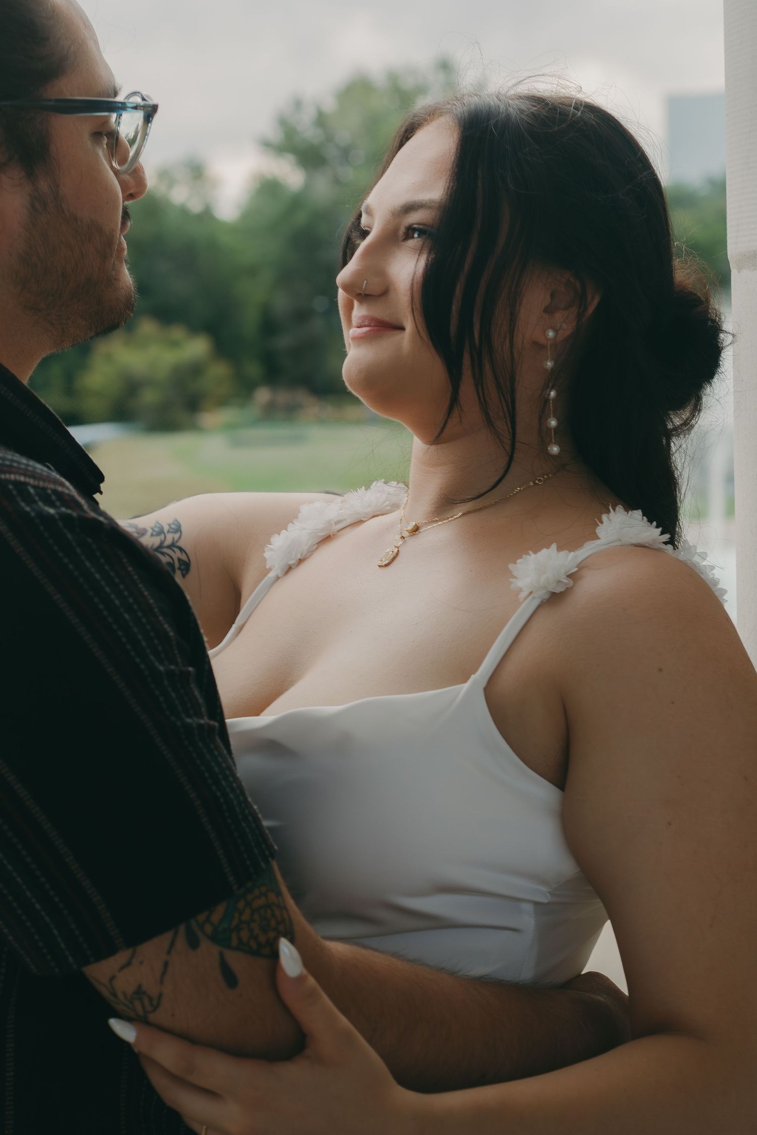 Intimate outdoor portrait session with soft natural lighting and urban background.