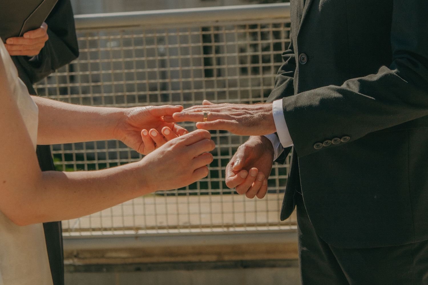 Hands exchanging red envelopes in traditional ceremony.