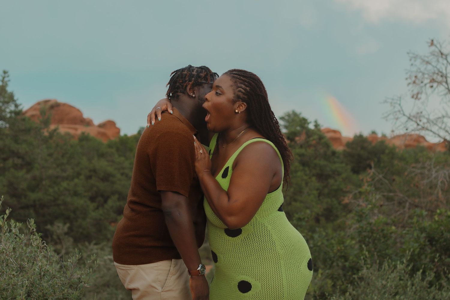 A romantic sunset moment captured against the backdrop of red rock formations and natural landscape.