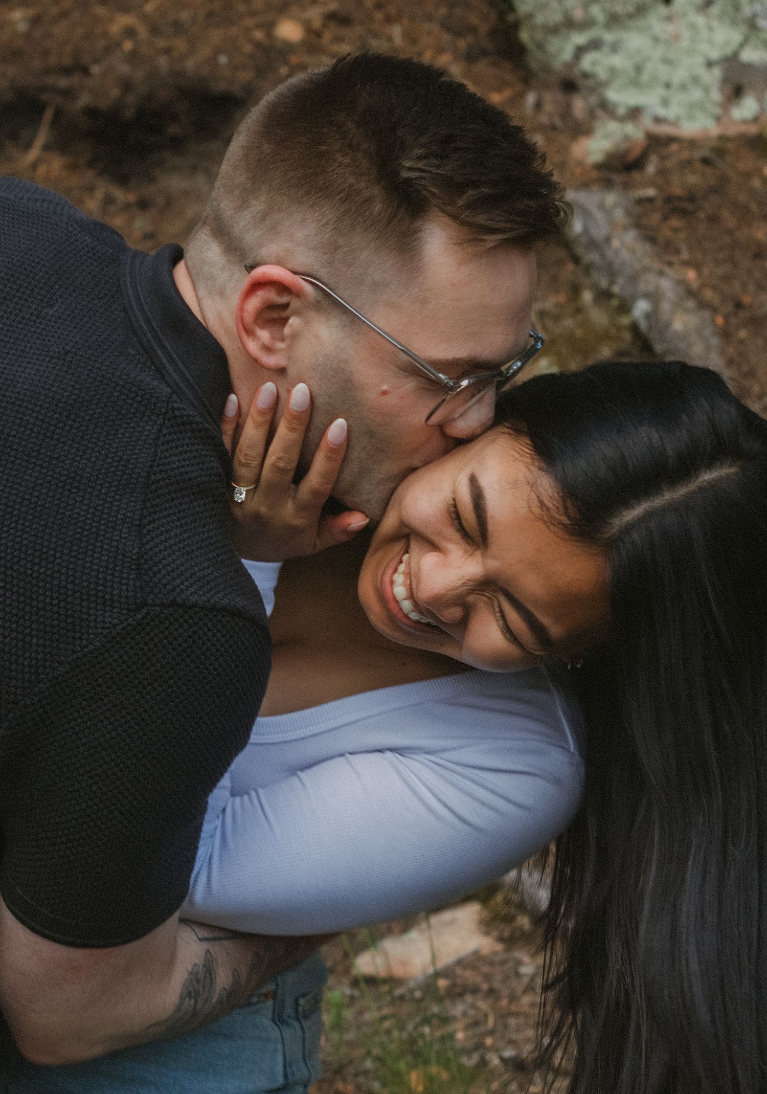 A joyful moment shared between two people with natural lighting in an outdoor setting.