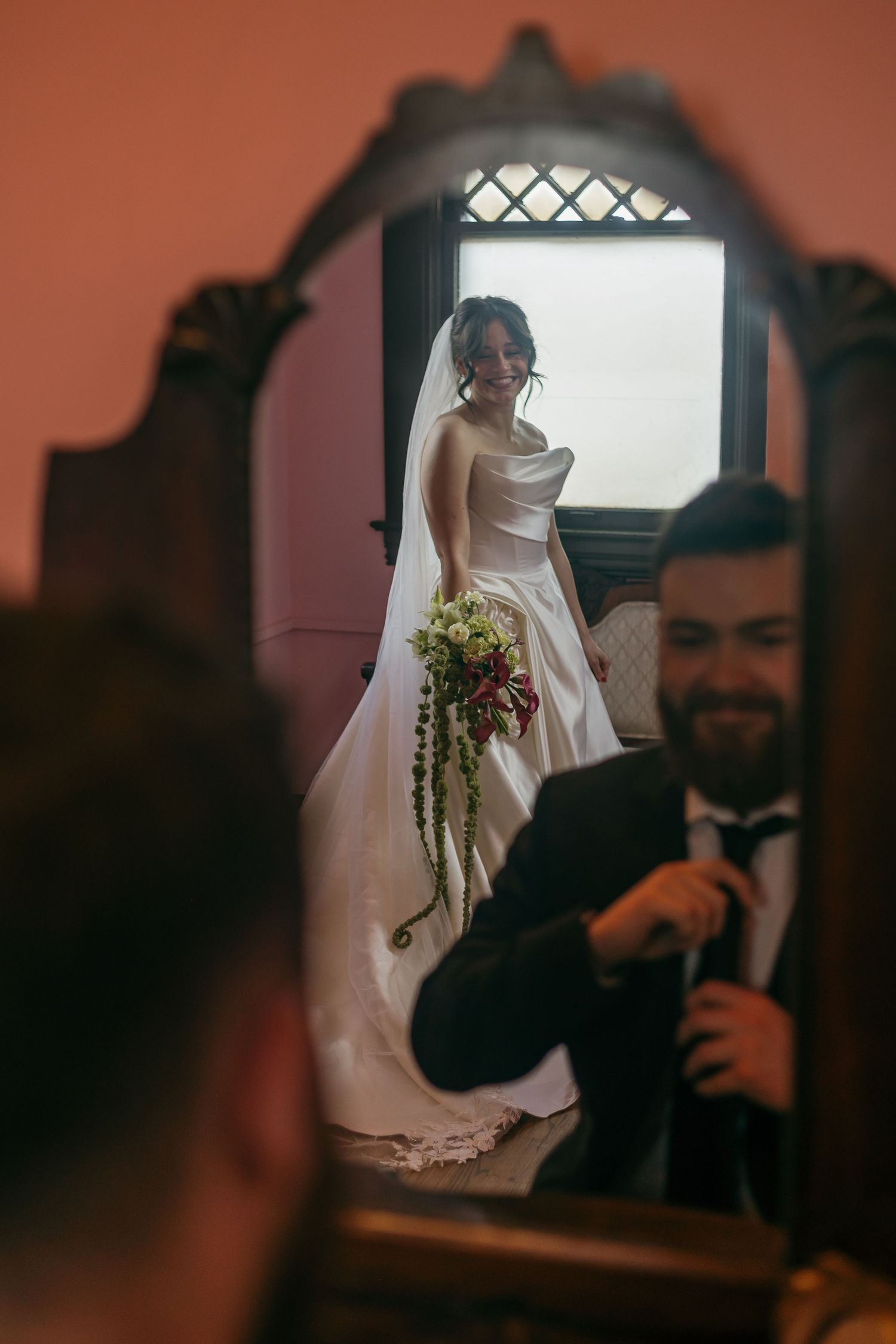 A wedding day preparation scene with a white dress in a warmly lit room.