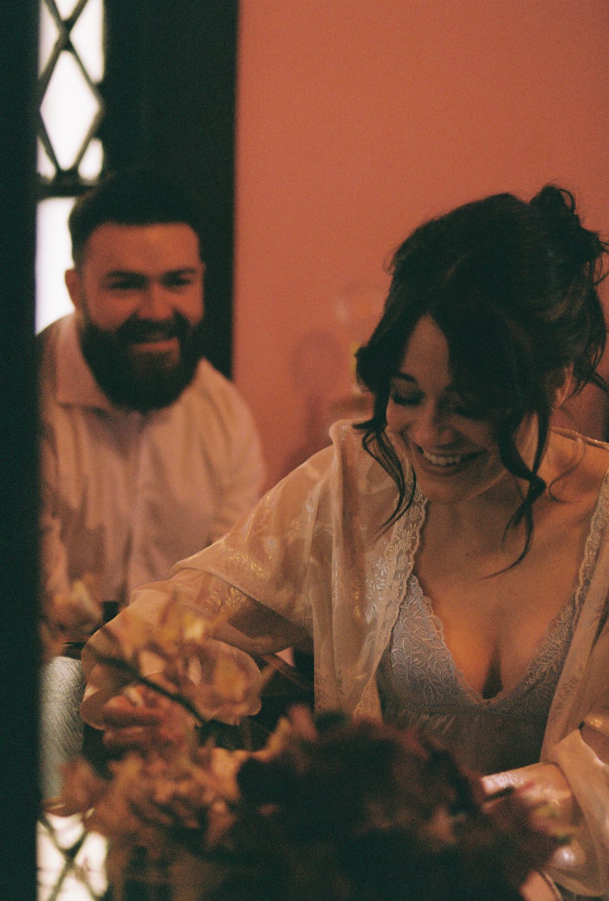 Warm-toned candid wedding reception scene with soft lighting.