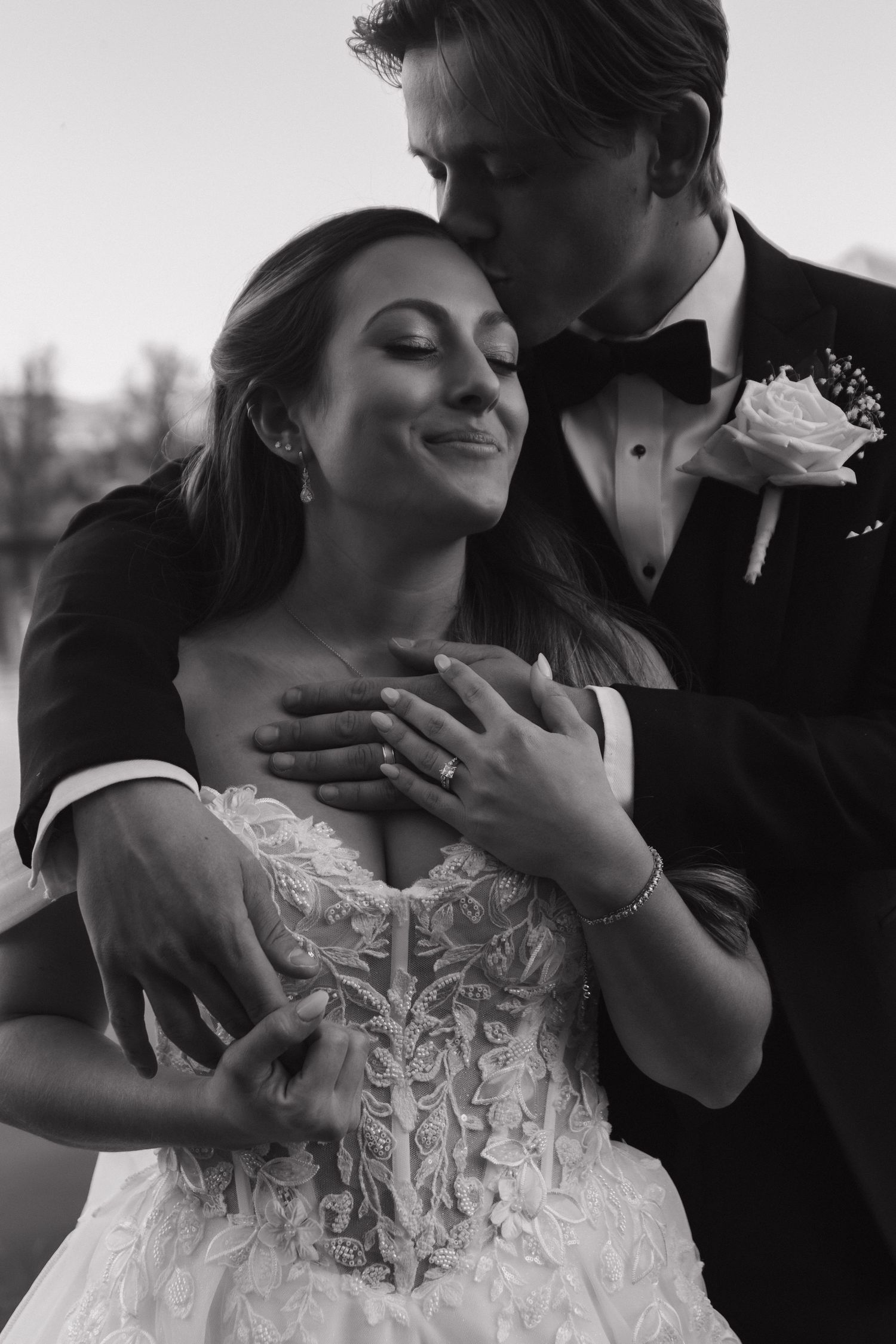 Intimate black and white wedding portraits capturing tender moments between newlyweds.