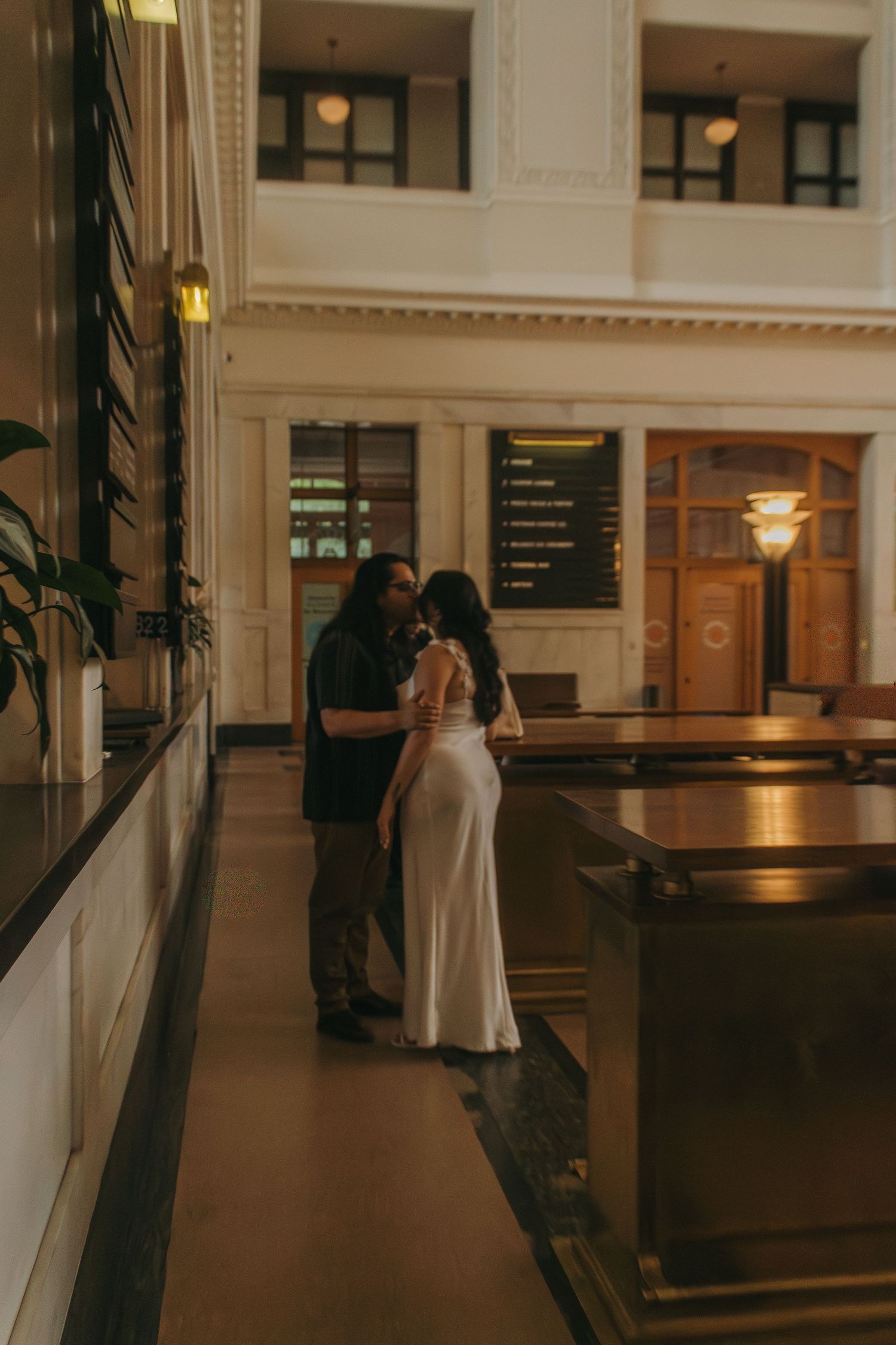 A vintage-style train station interior with elegant architectural details and warm lighting.