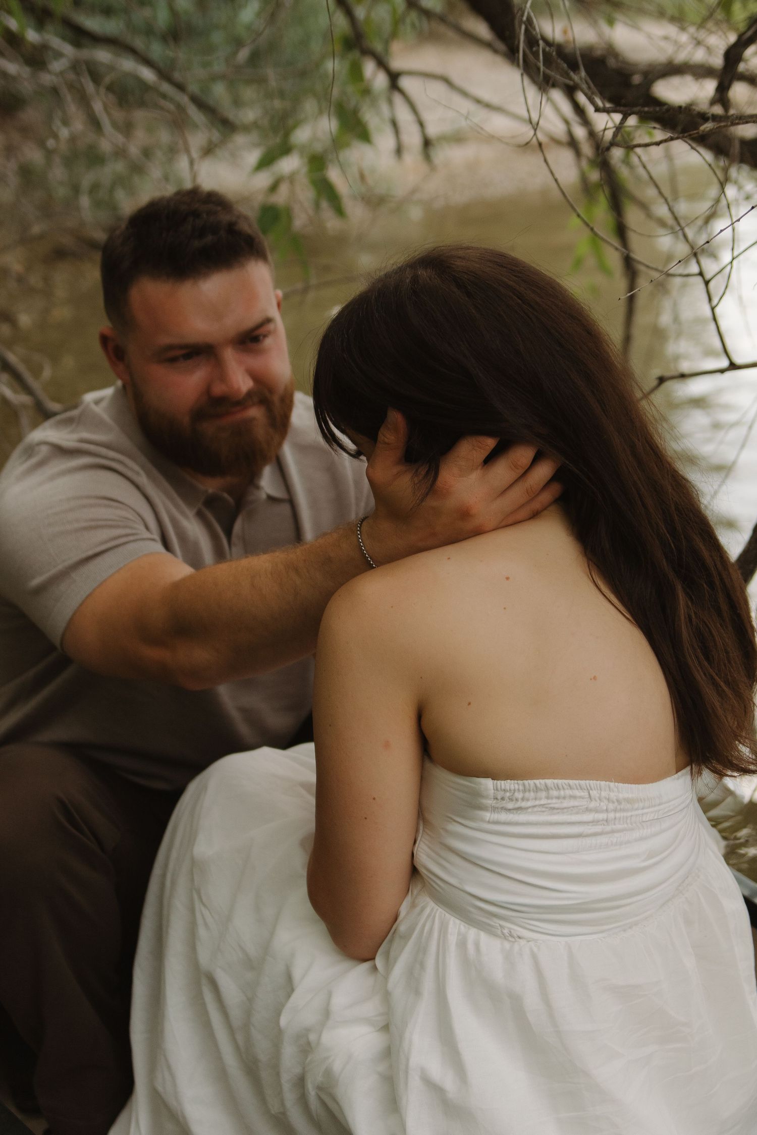 Romantic boat session with couple in white dress and grey shirt.