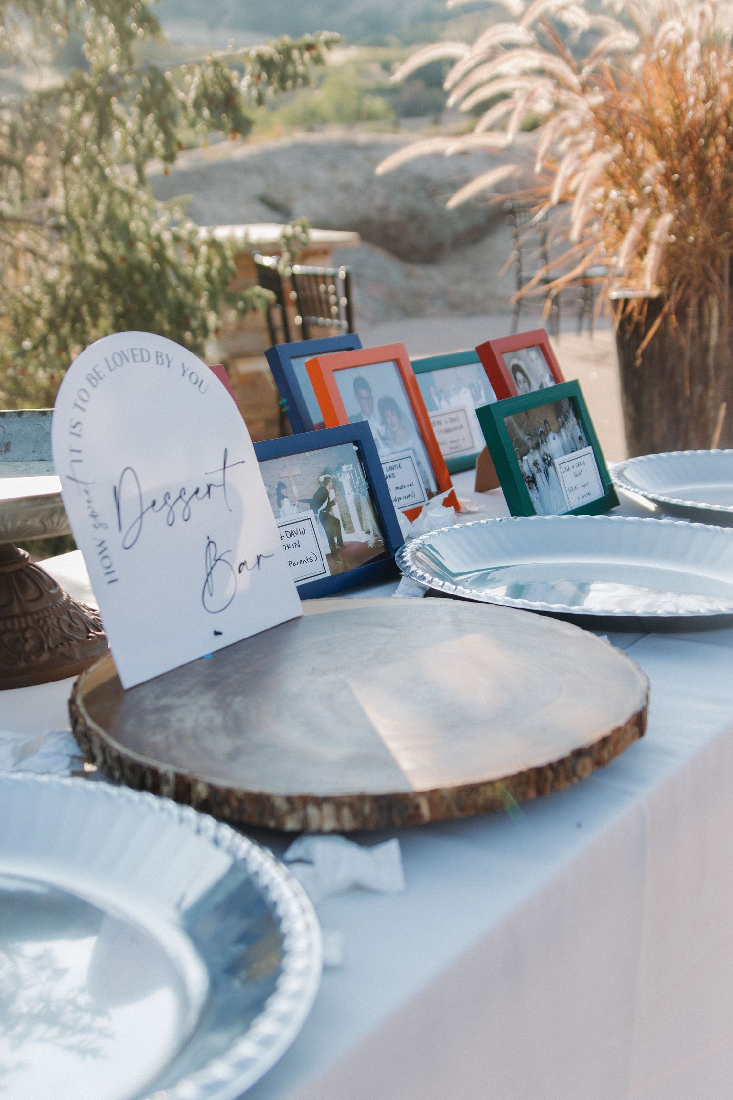 Place cards and table settings arranged on rustic wood slices at an elegant reception.
