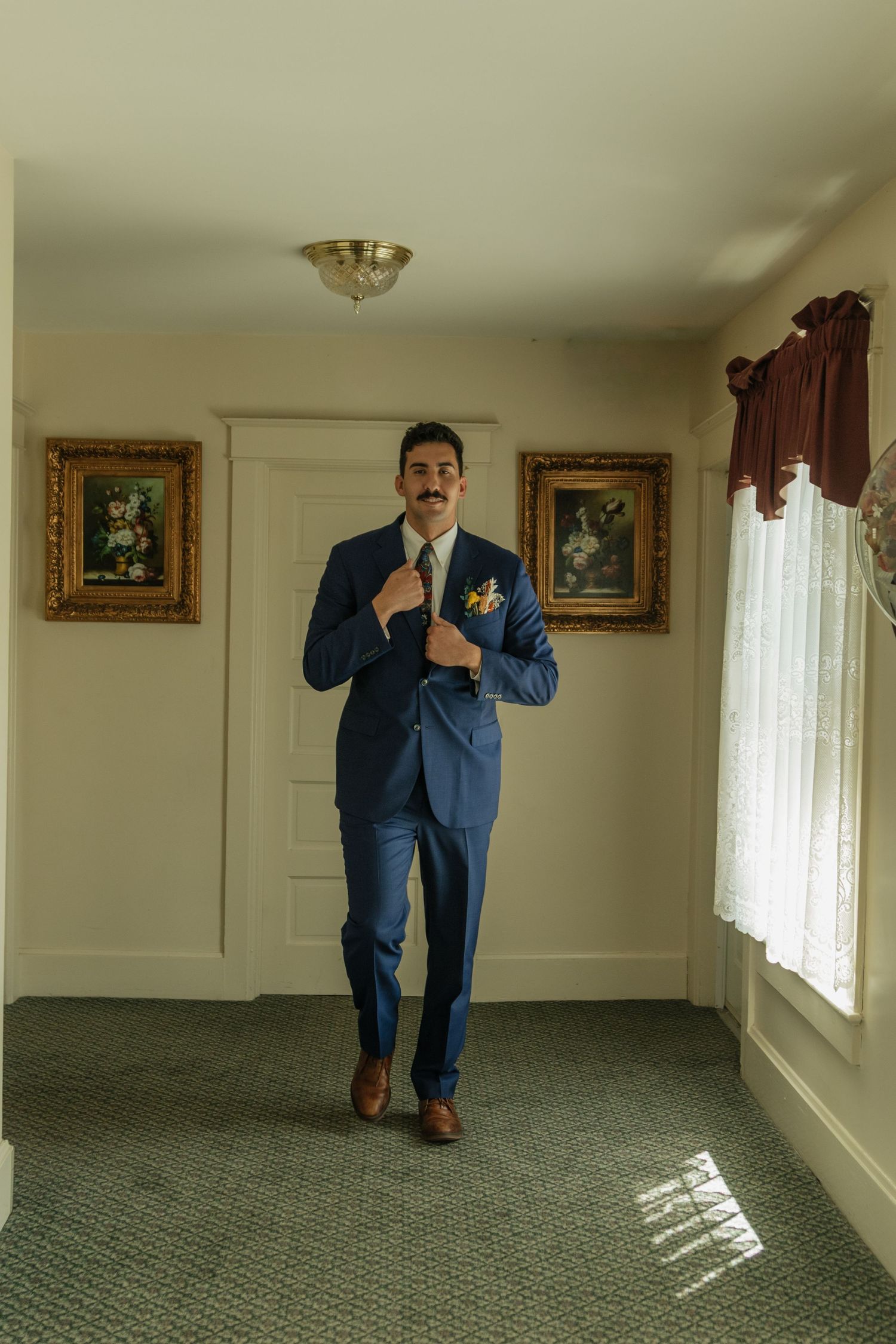 Series of playful poses in blue suit showing various fun angles on carpeted floor.