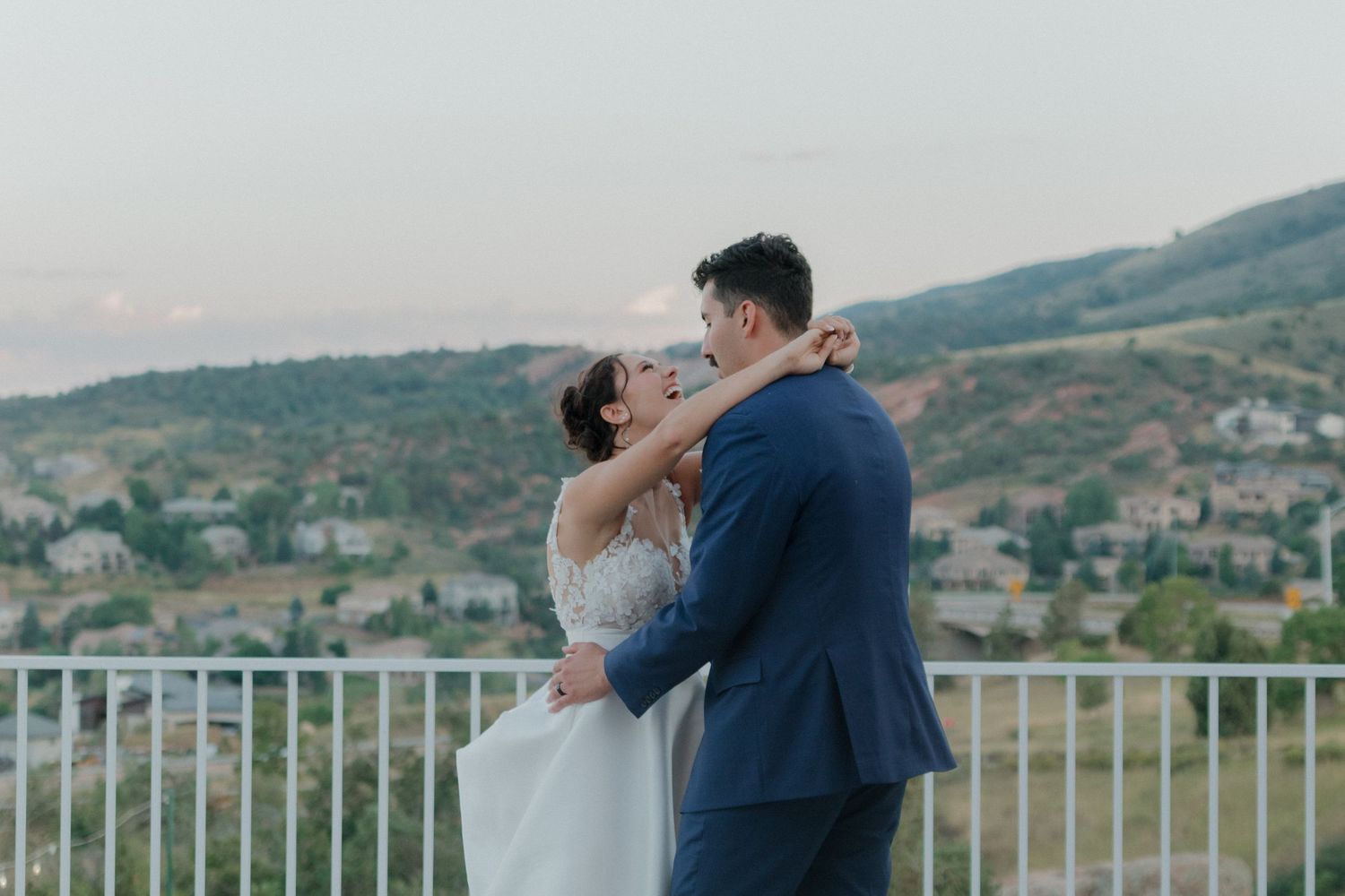 A romantic outdoor balcony setting with mountains in the background.