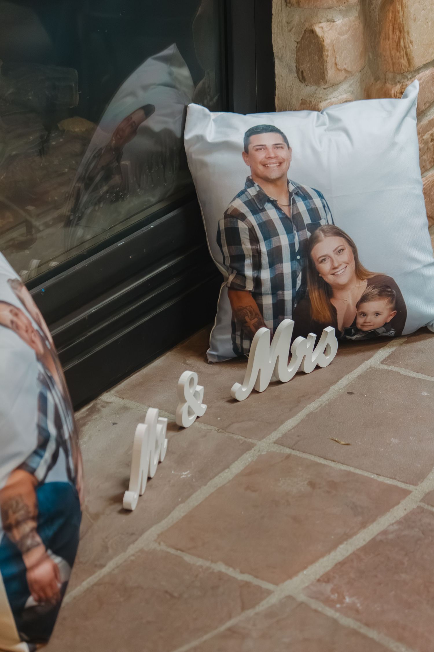 Decorative 'Mr & Mrs' lettering with custom photo pillows on display.