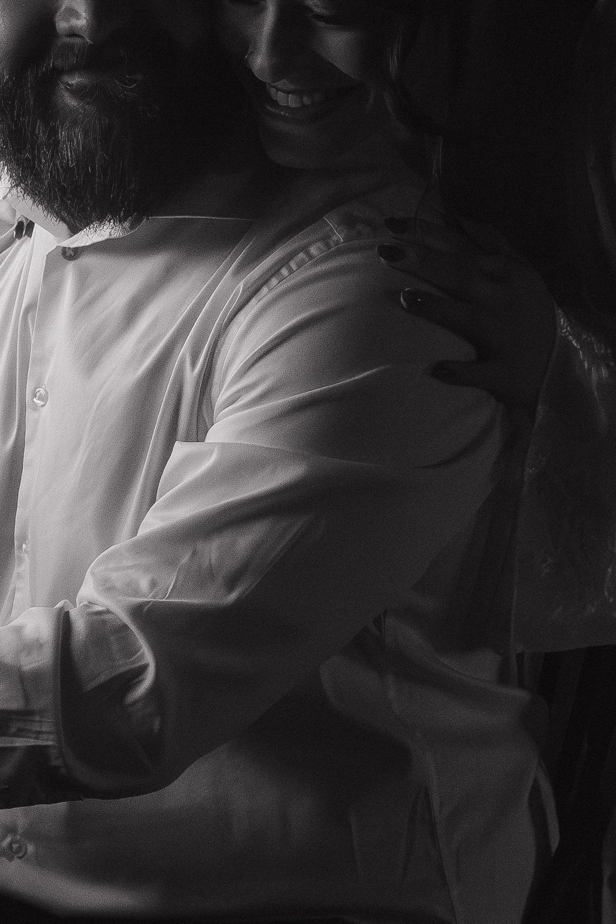 Intimate black and white wedding moments captured in dramatic lighting.
