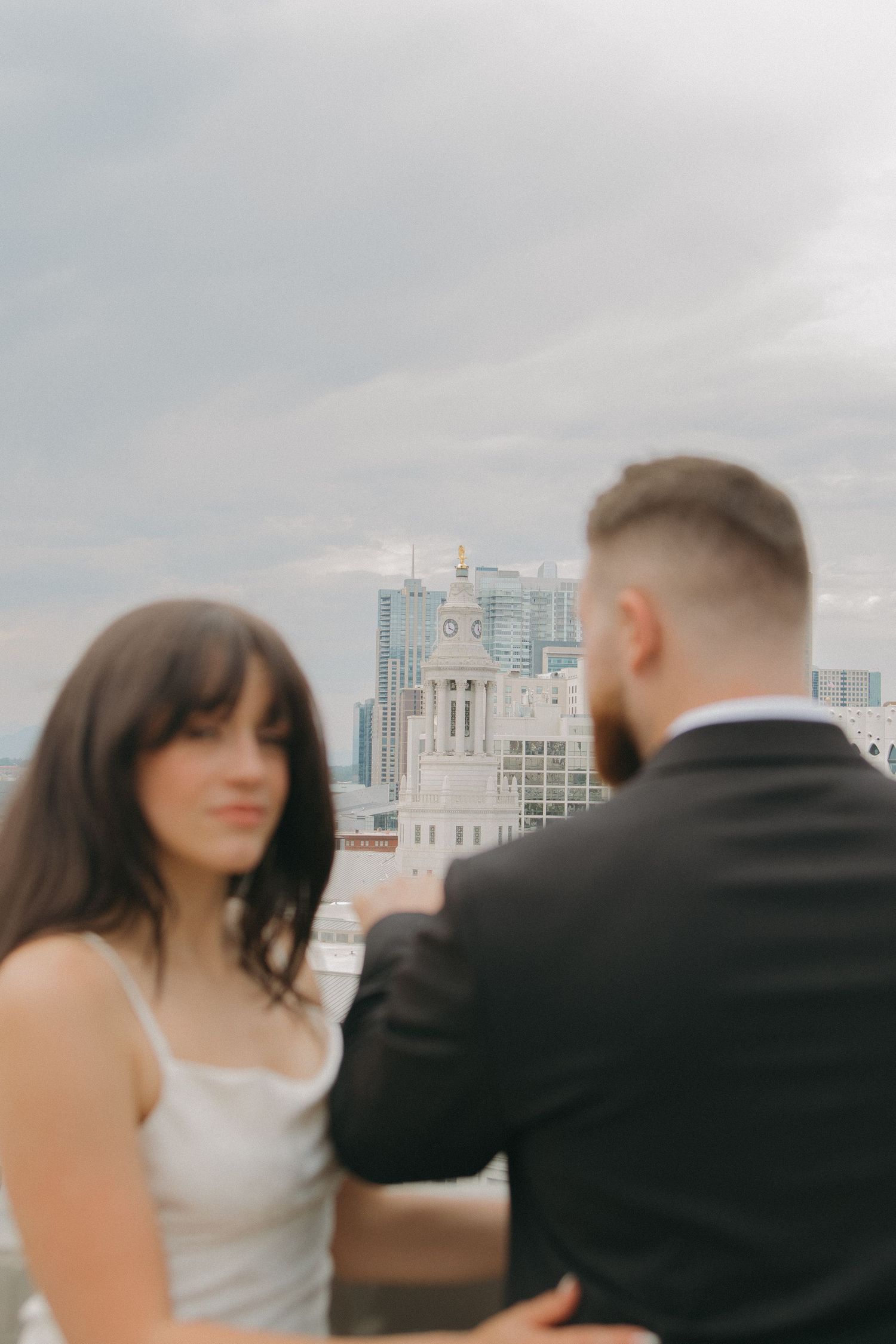Couple in wedding attire photographed against city skyline in sequential motion shots.
