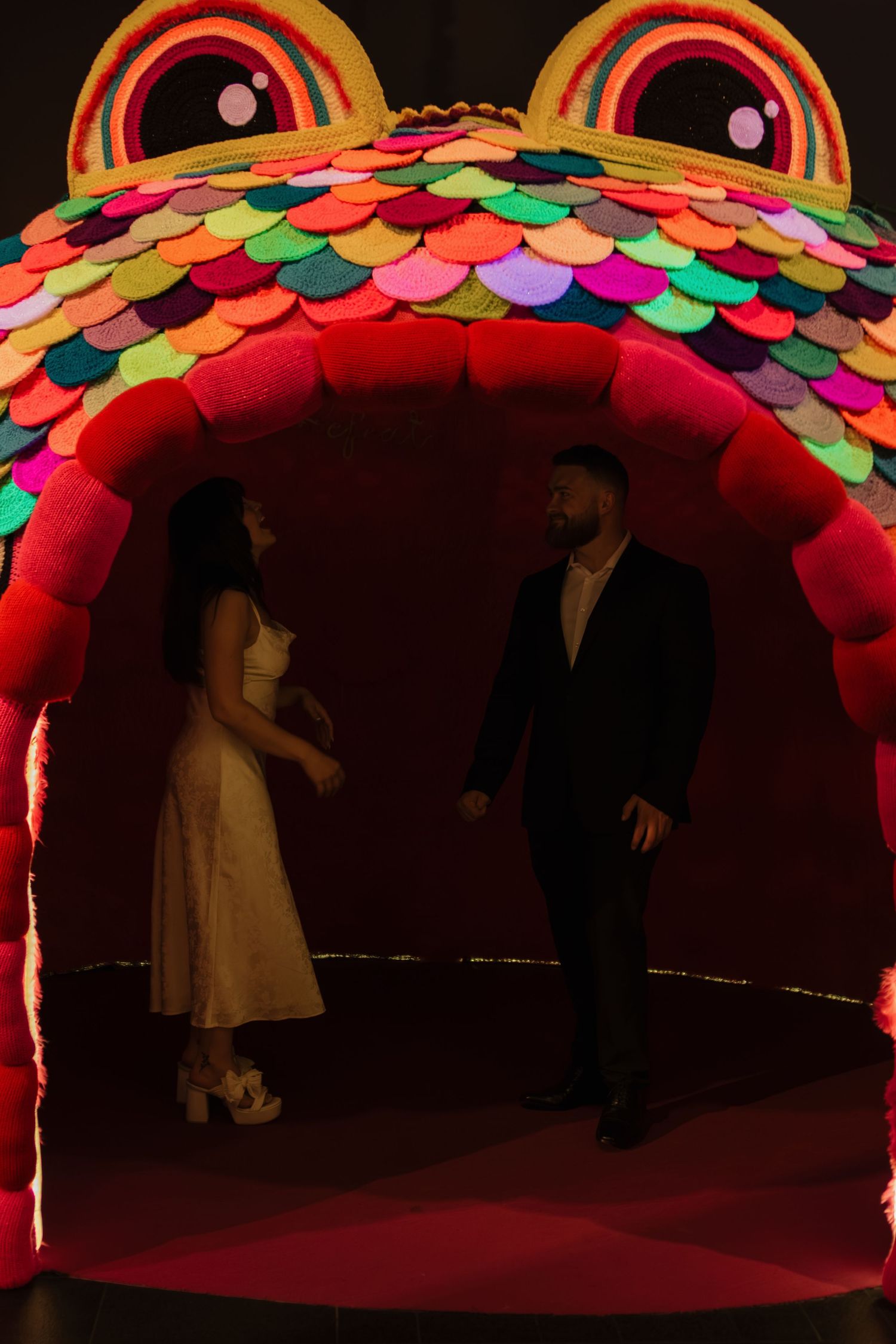 Colorful illuminated tunnel with circular patterns and LED lights creating a vibrant rainbow effect.