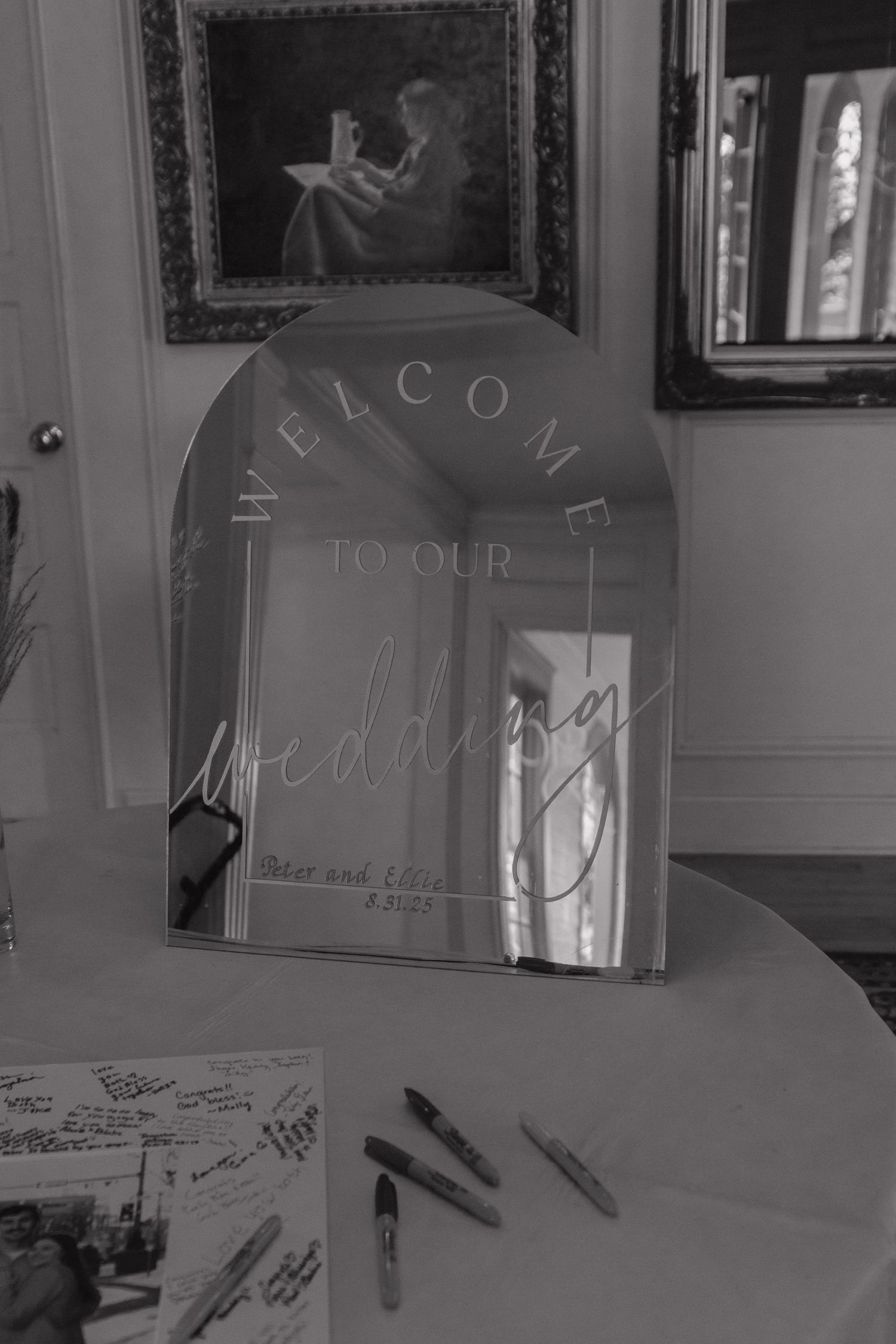 A guestbook signing station with white pages and pens at a formal event.