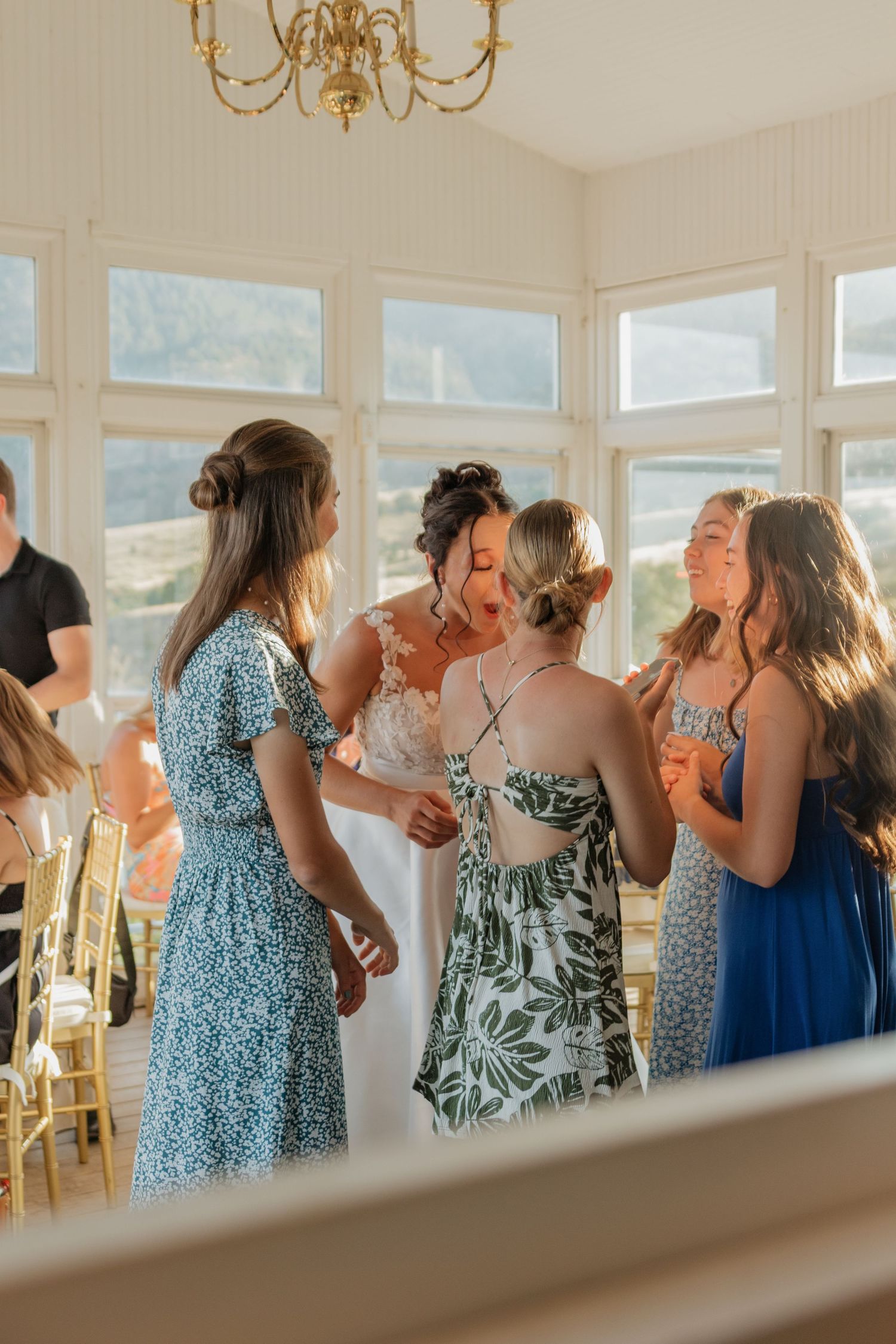 Wedding party celebrating and dancing in an elegant indoor venue.