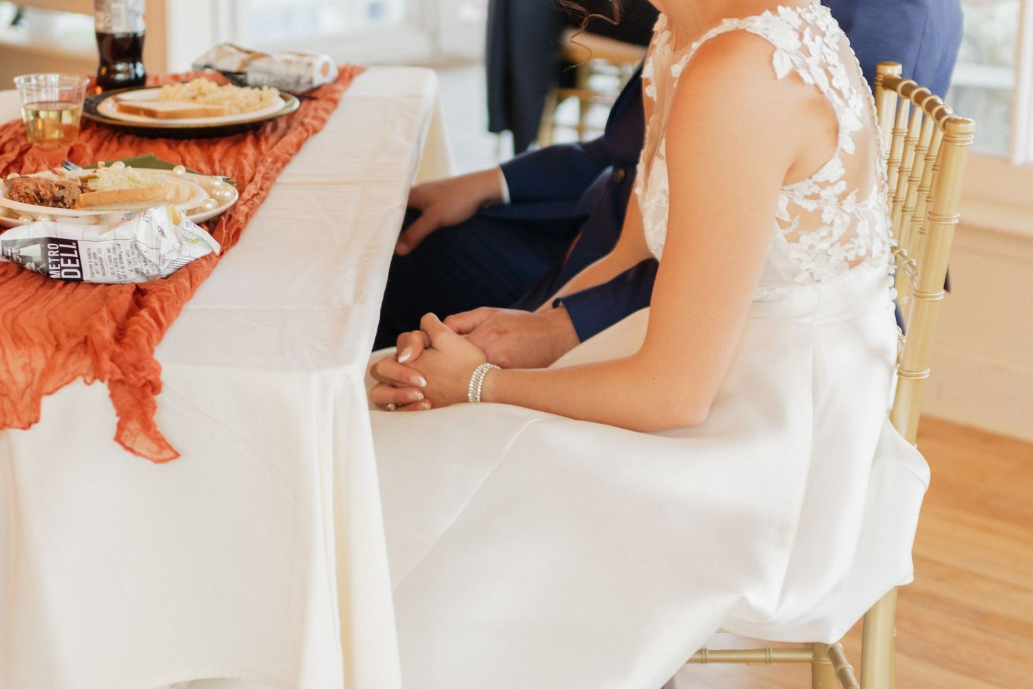 Elegant wedding details showing dress and table settings in soft natural light.