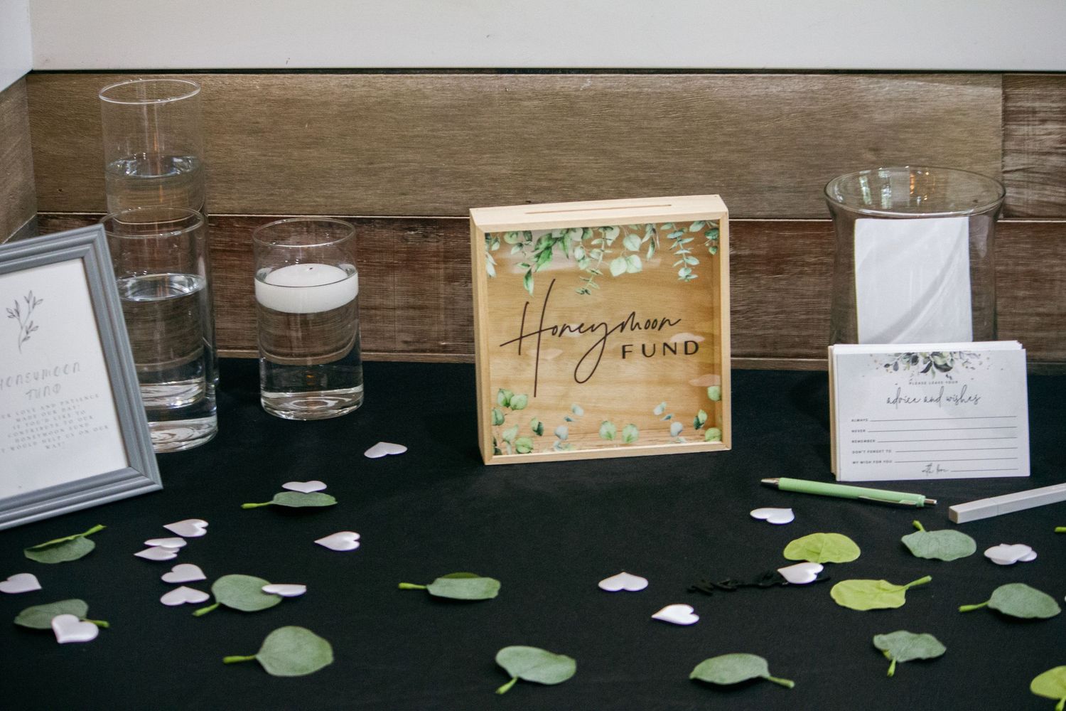 Wedding table decor with scattered hearts and rustic wooden elements.