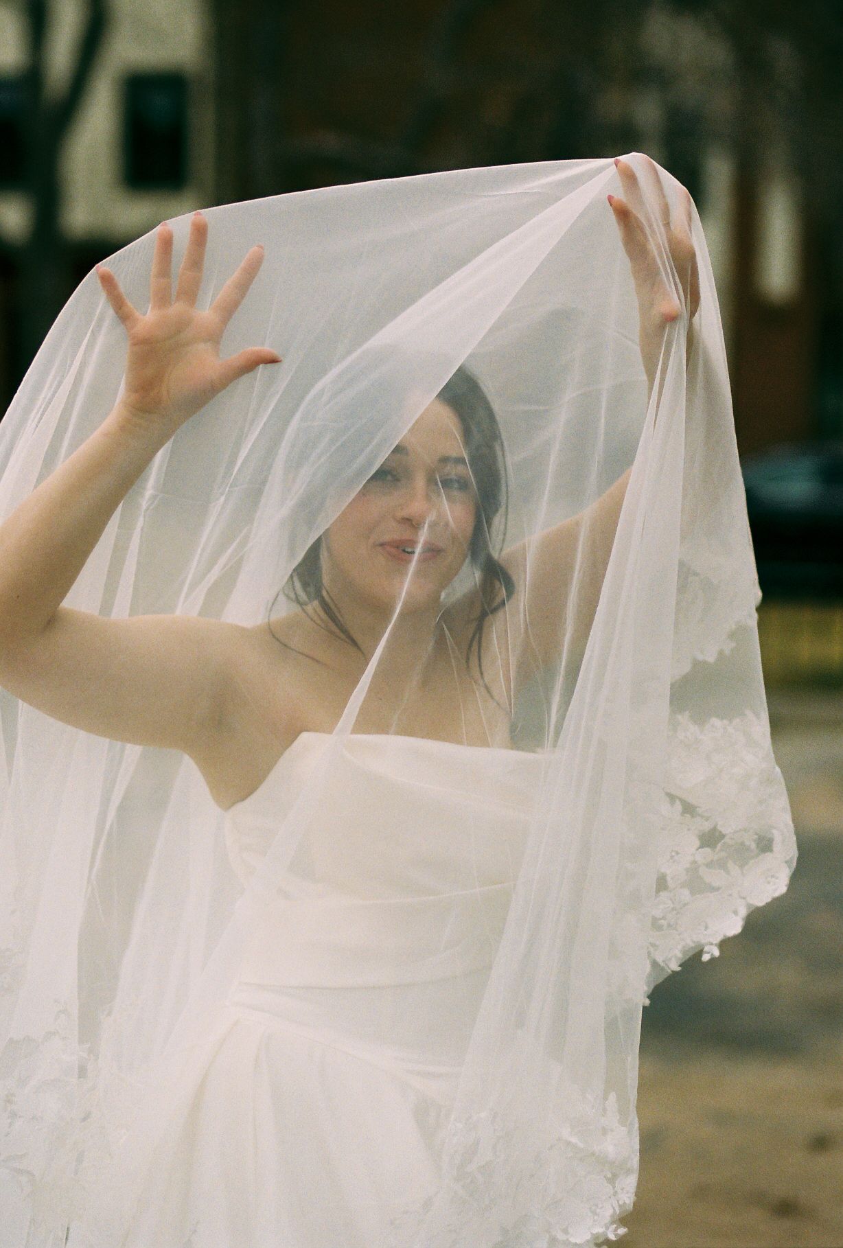 Artistic bridal portraits with flowing veil captured in natural outdoor light.