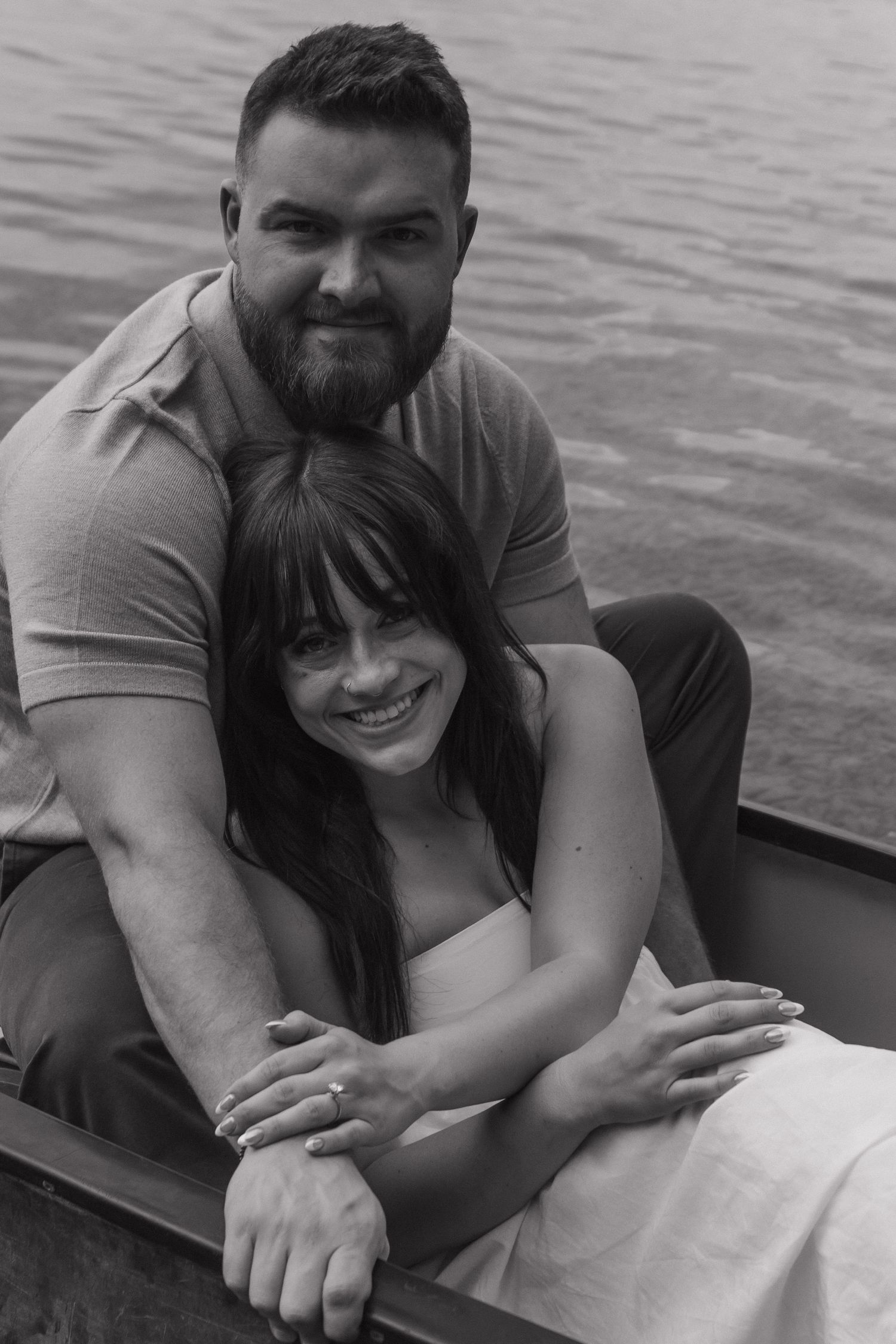 A playful black and white photo series of a couple embracing by the water.