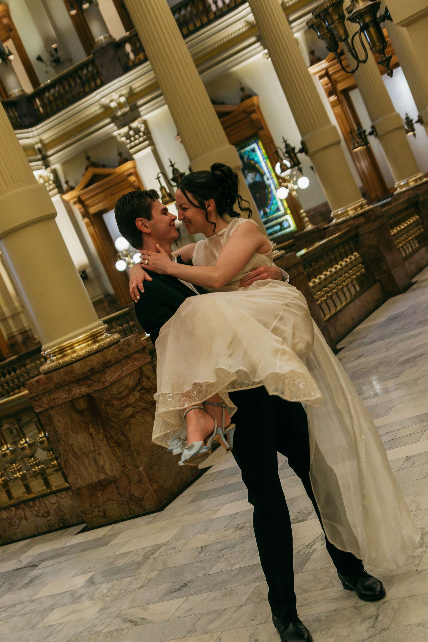 A romantic wedding dance dip sequence in an elegant marble columned hallway.