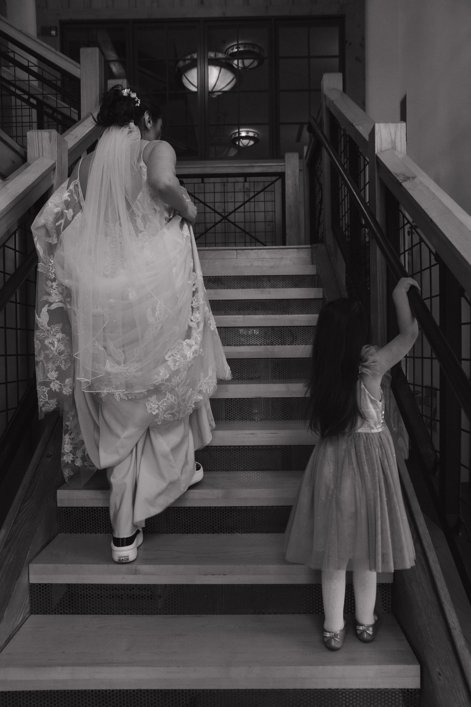 Black and white photo series showing flowing dresses and formal attire on stairs.