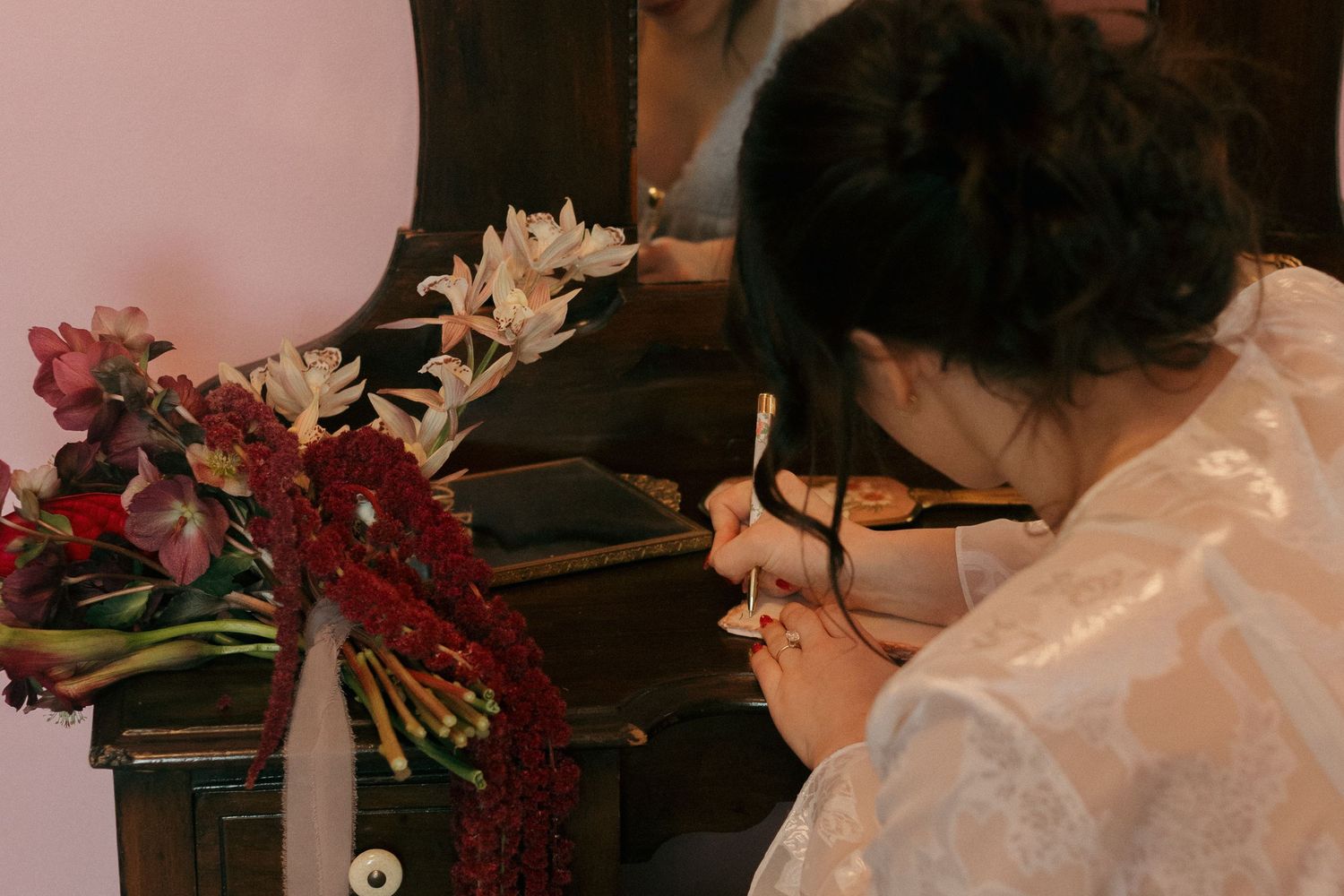 Wedding dress preparation scene with delicate details being arranged.