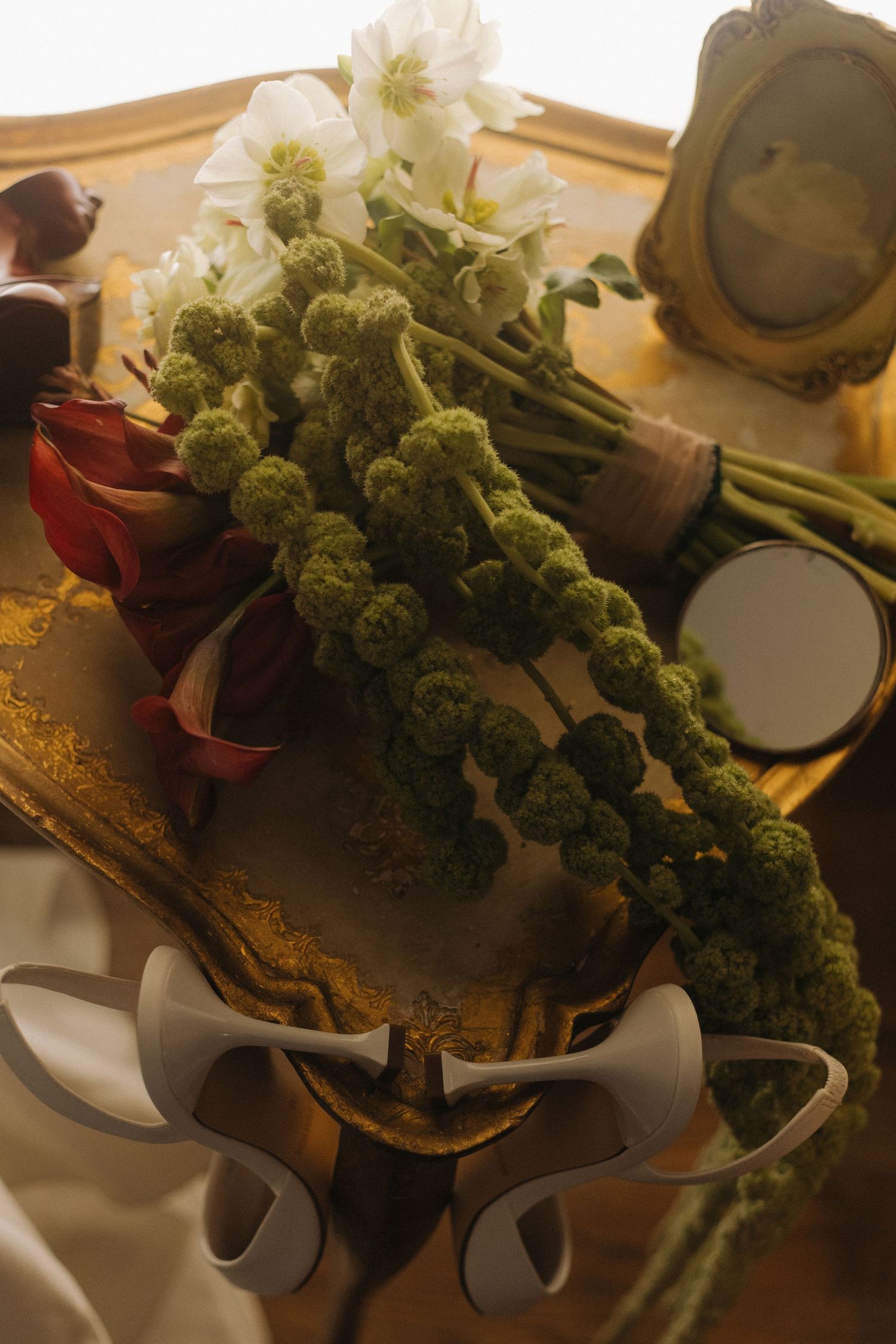 Fresh green and white floral arrangements displayed on a rustic wooden surface.