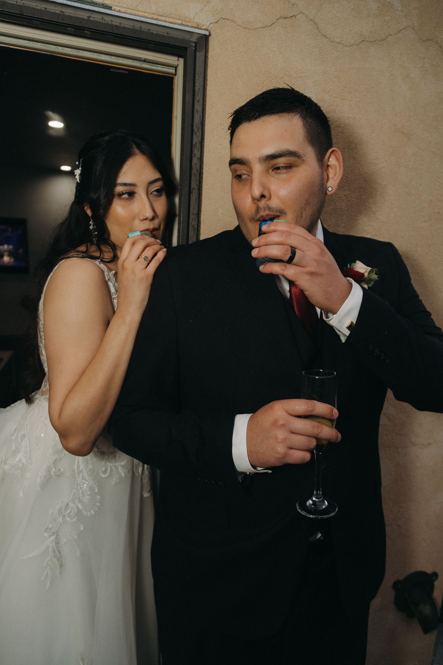 Bride and groom enjoy macarons and champagne together during their wedding reception celebration.