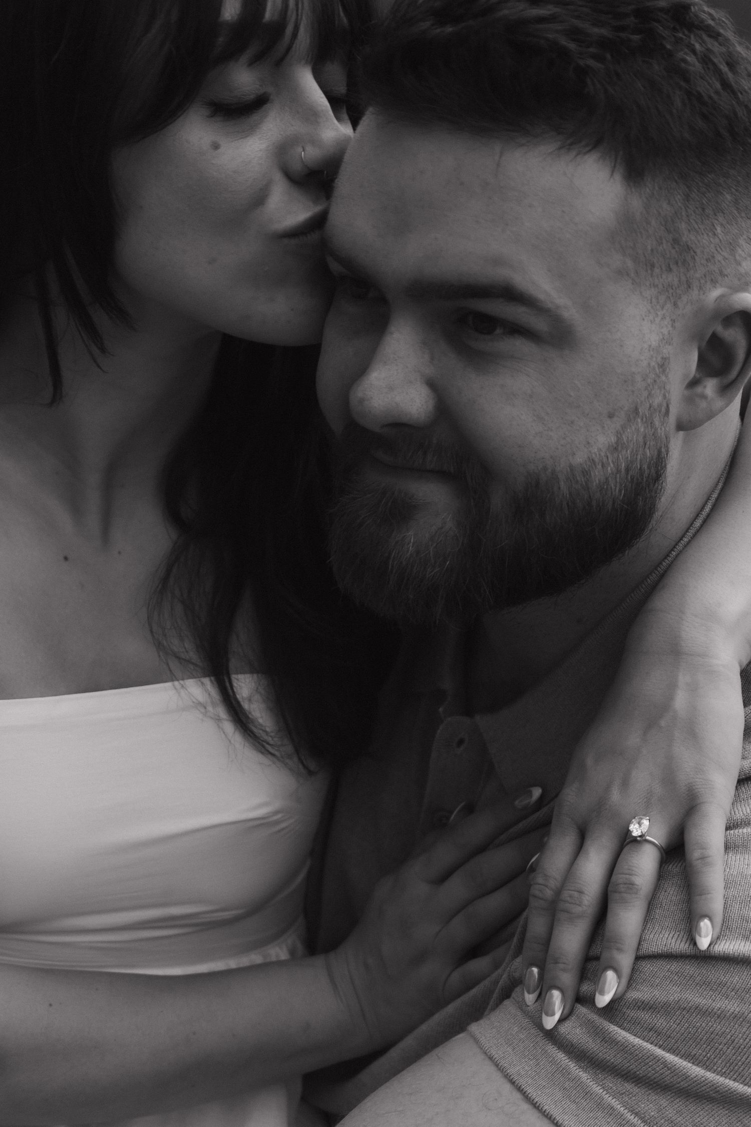 Black and white intimate portrait showing gentle expressions and tender touch.
