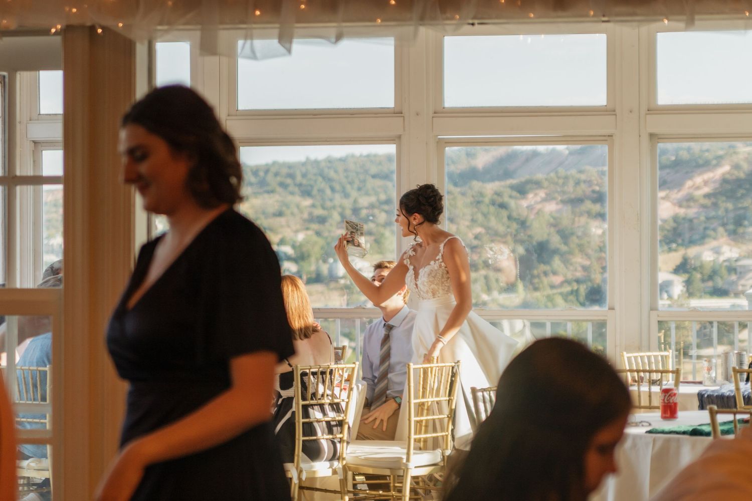Empty wedding reception venue with chiavari chairs and mountain views.