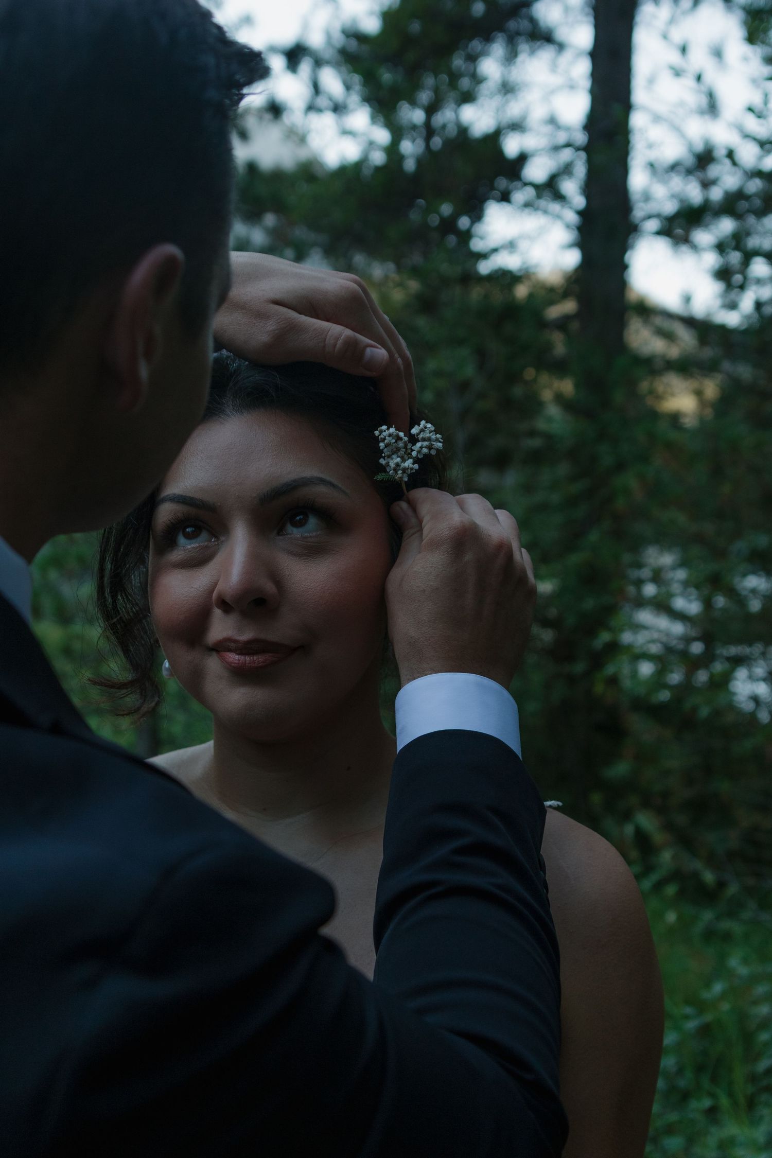 Close-up intimate moment between couple in natural outdoor setting.