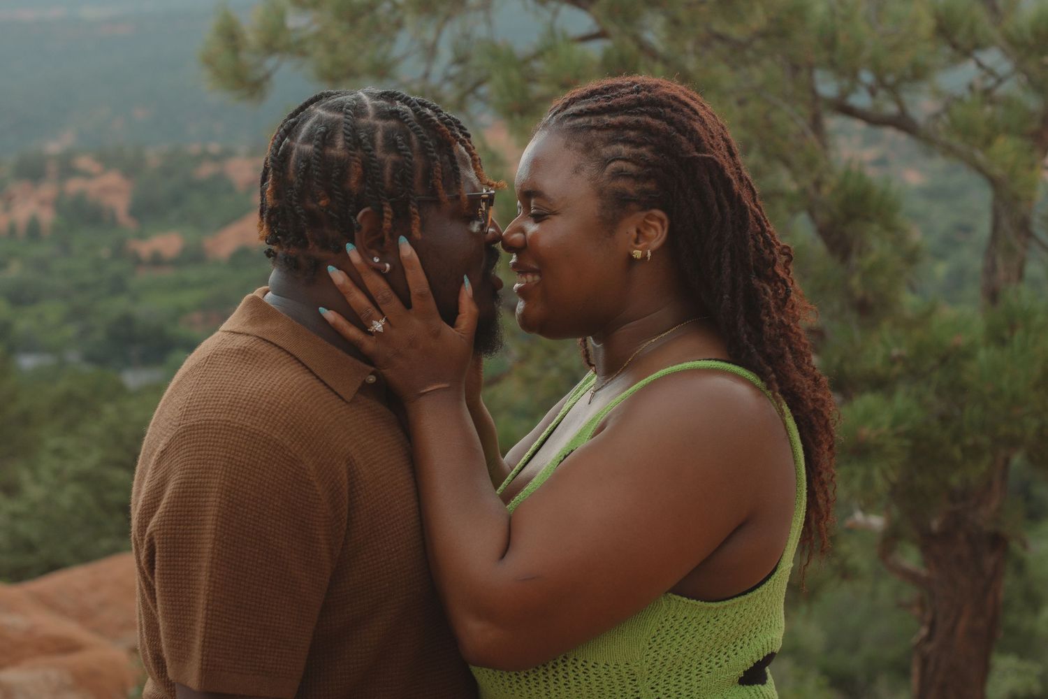 Tender moment captured during outdoor engagement photography session.