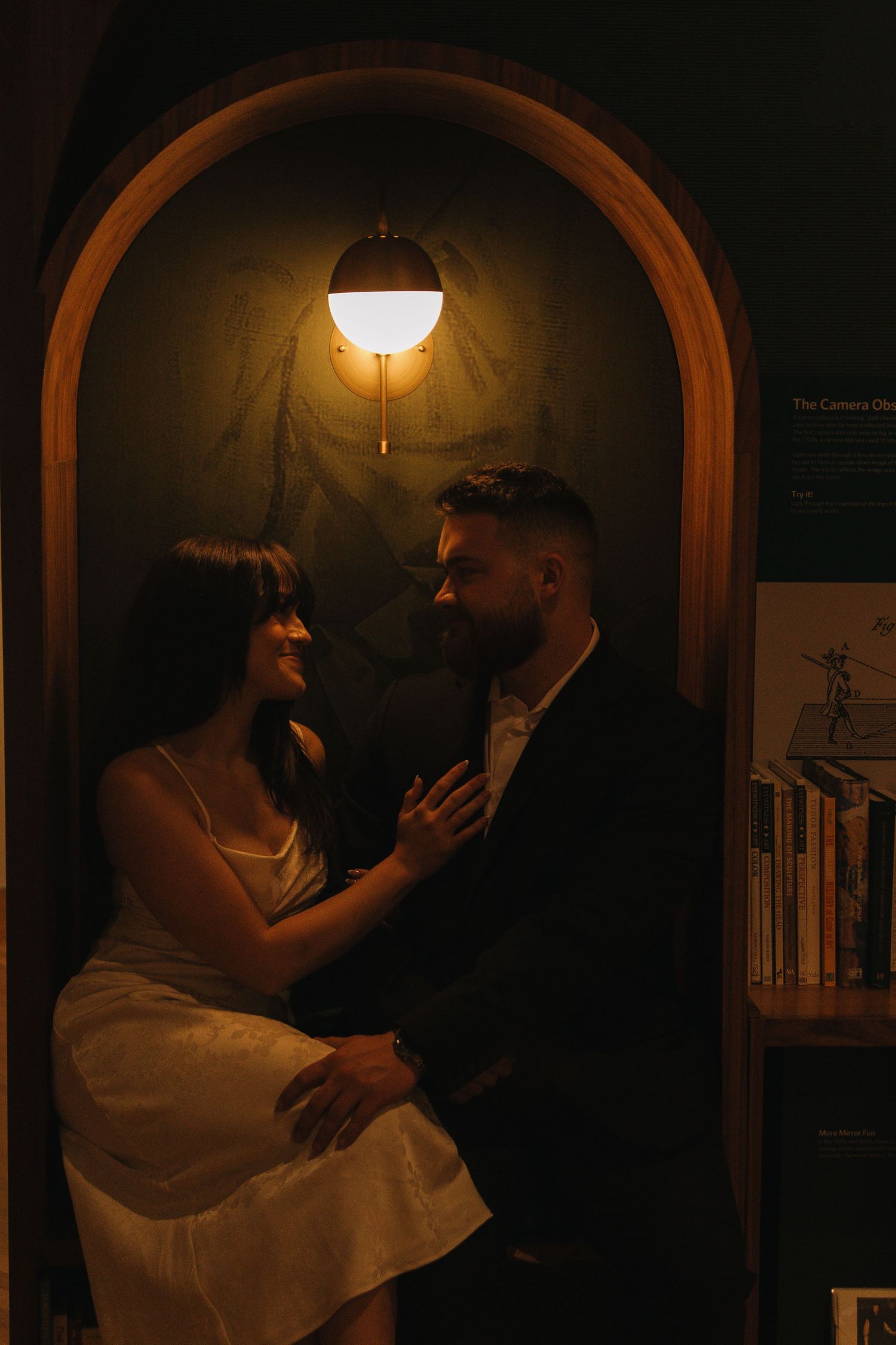 A romantic dance moment captured under an arched doorway with soft lighting.