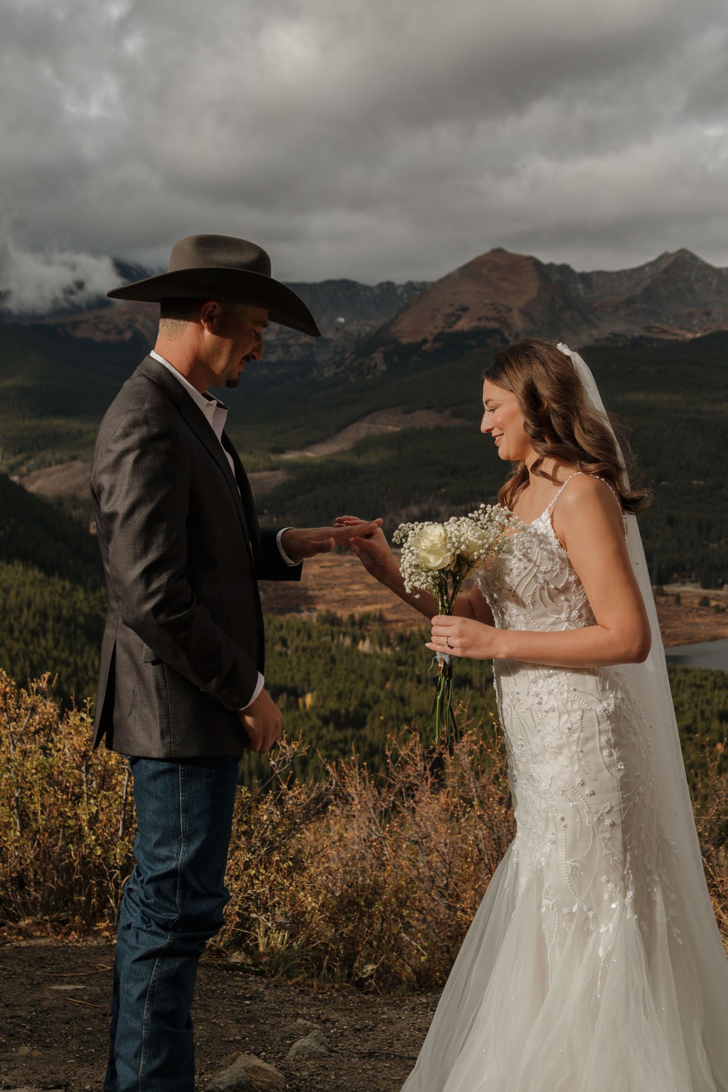 A couple exchanges vows during their mountain-top wedding ceremony.