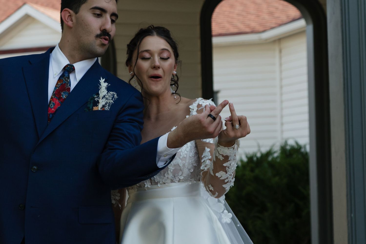 Wedding celebration with couple dancing indoors near windows.