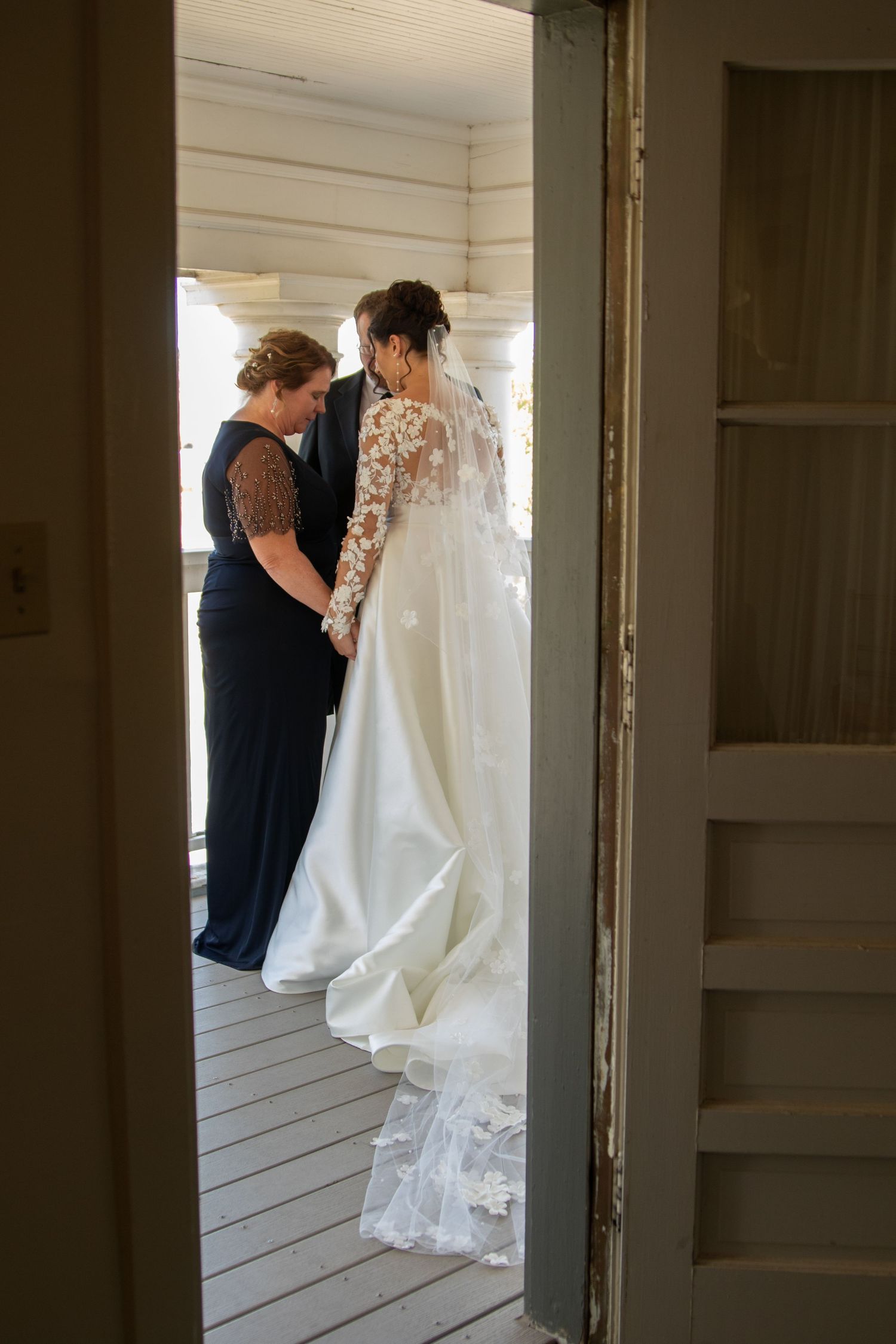 A heartfelt first look moment between wedding participants in a rustic interior.